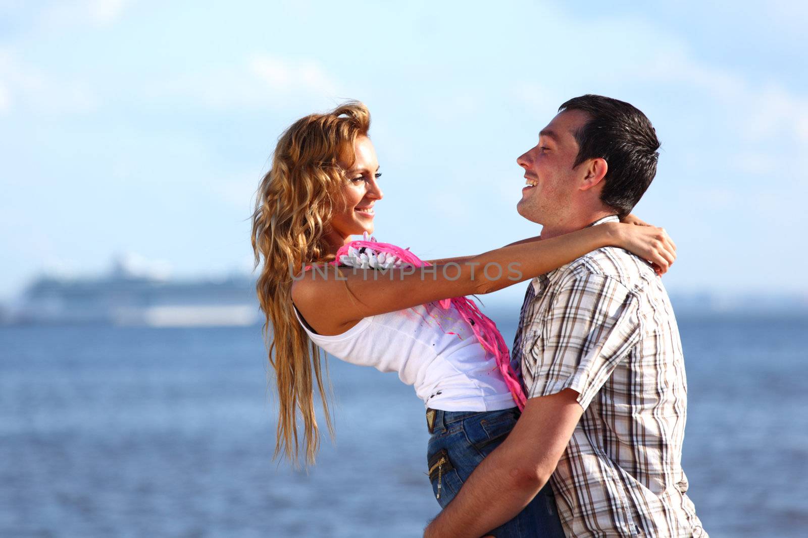 man and woman hug in the sky and sea on sea