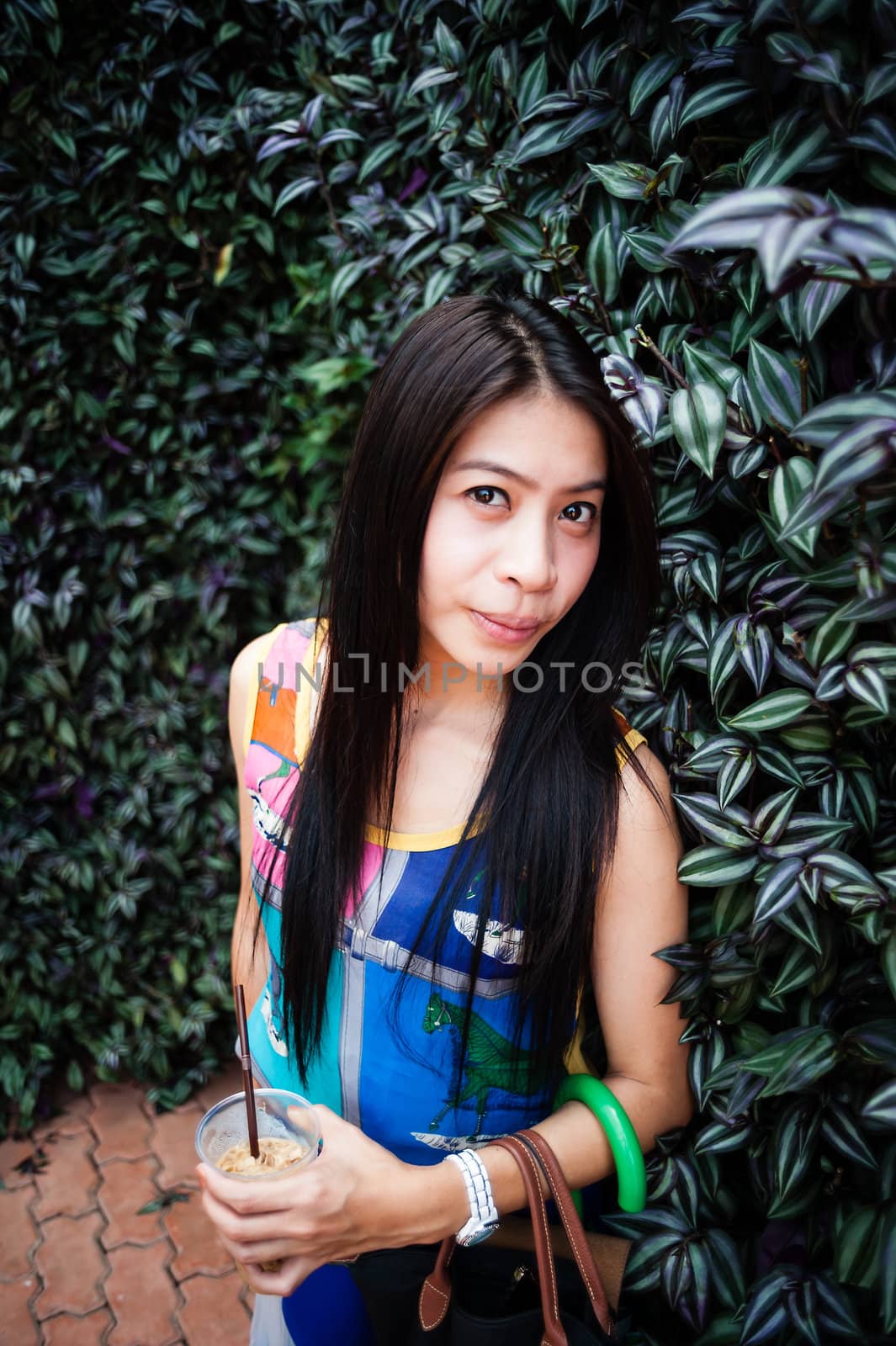 Portrait woman asian girl with wall leaf in the garden
