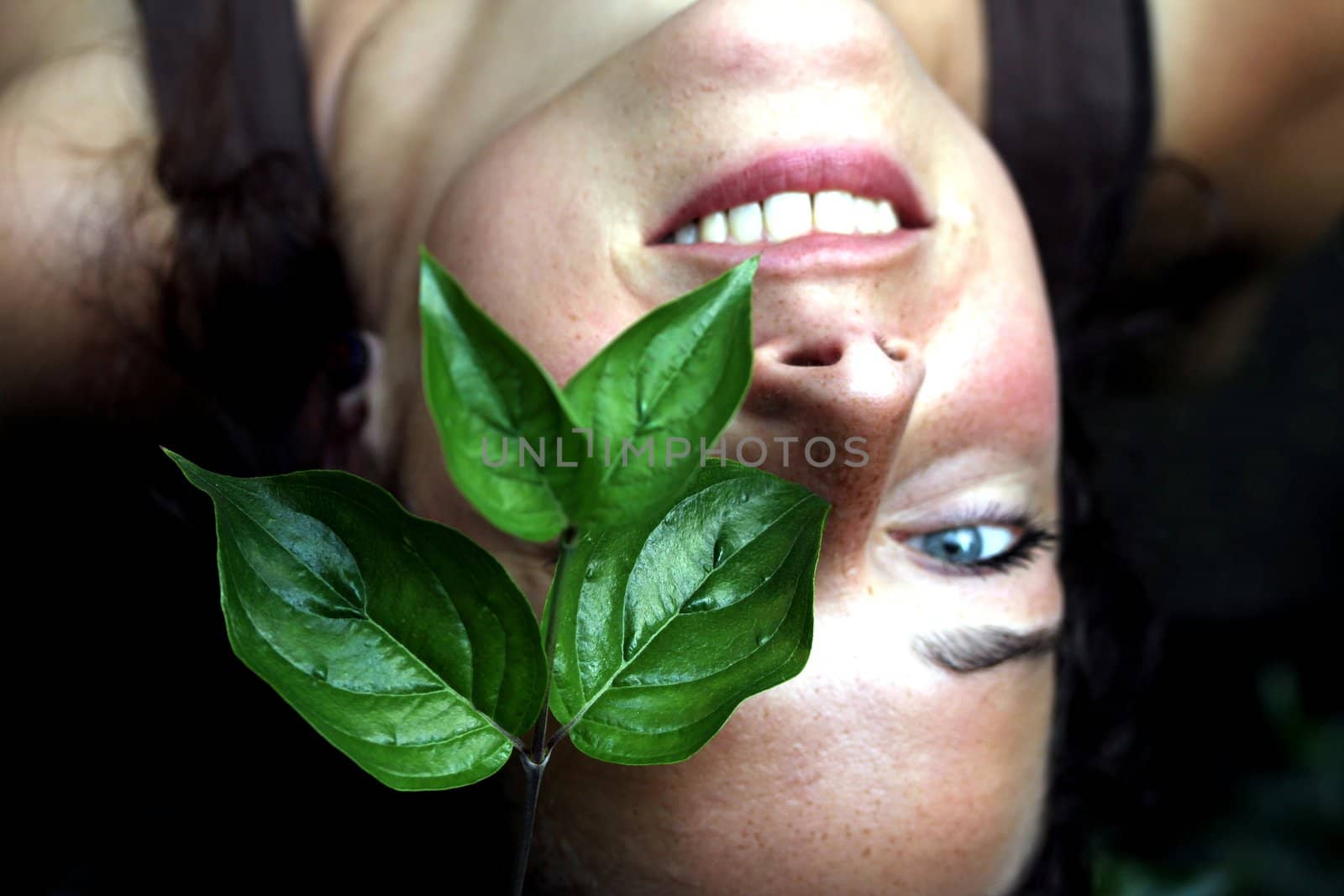 young woman with green foliage