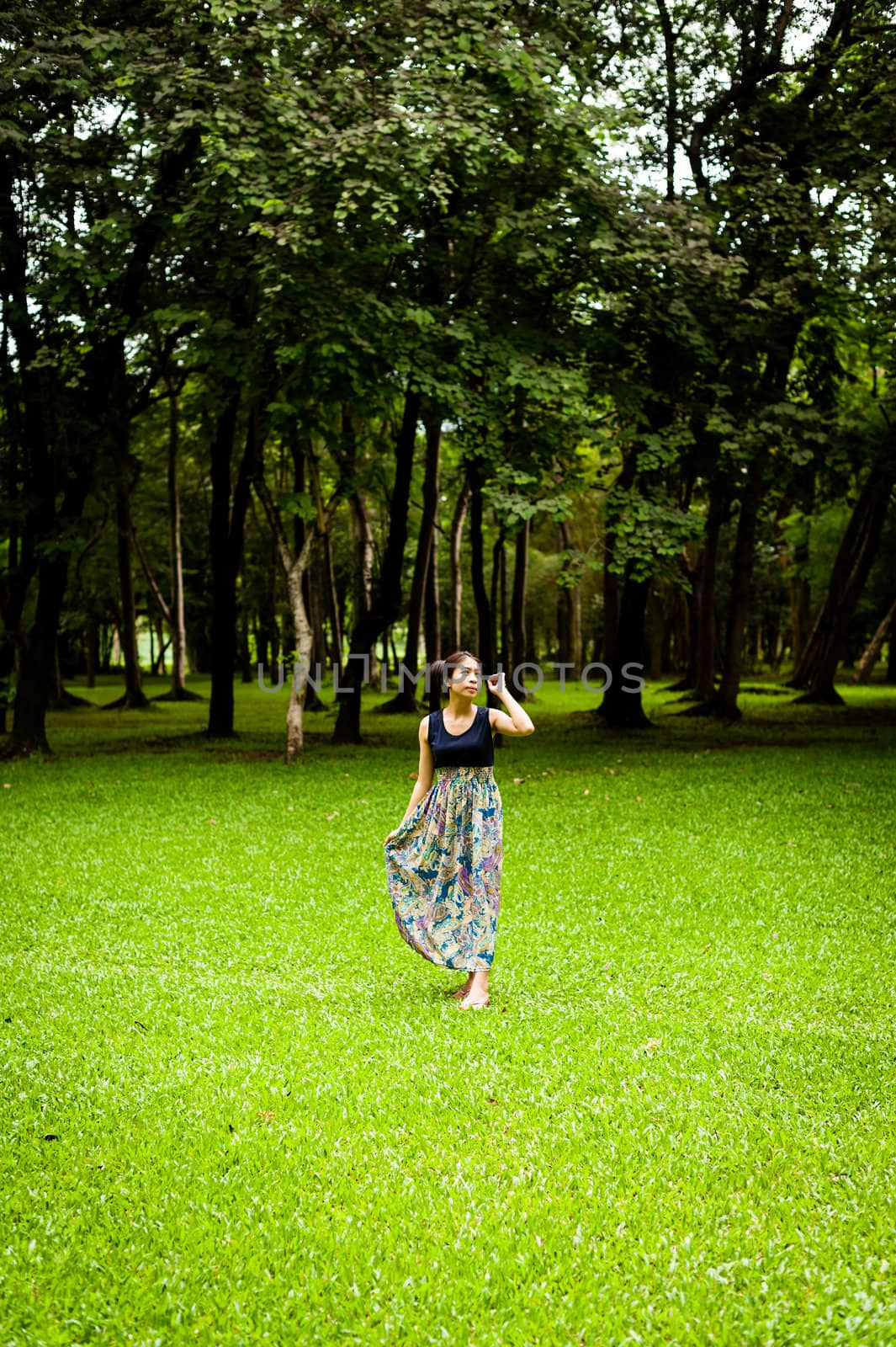 Portrait woman asian girl with tree background  in the garden