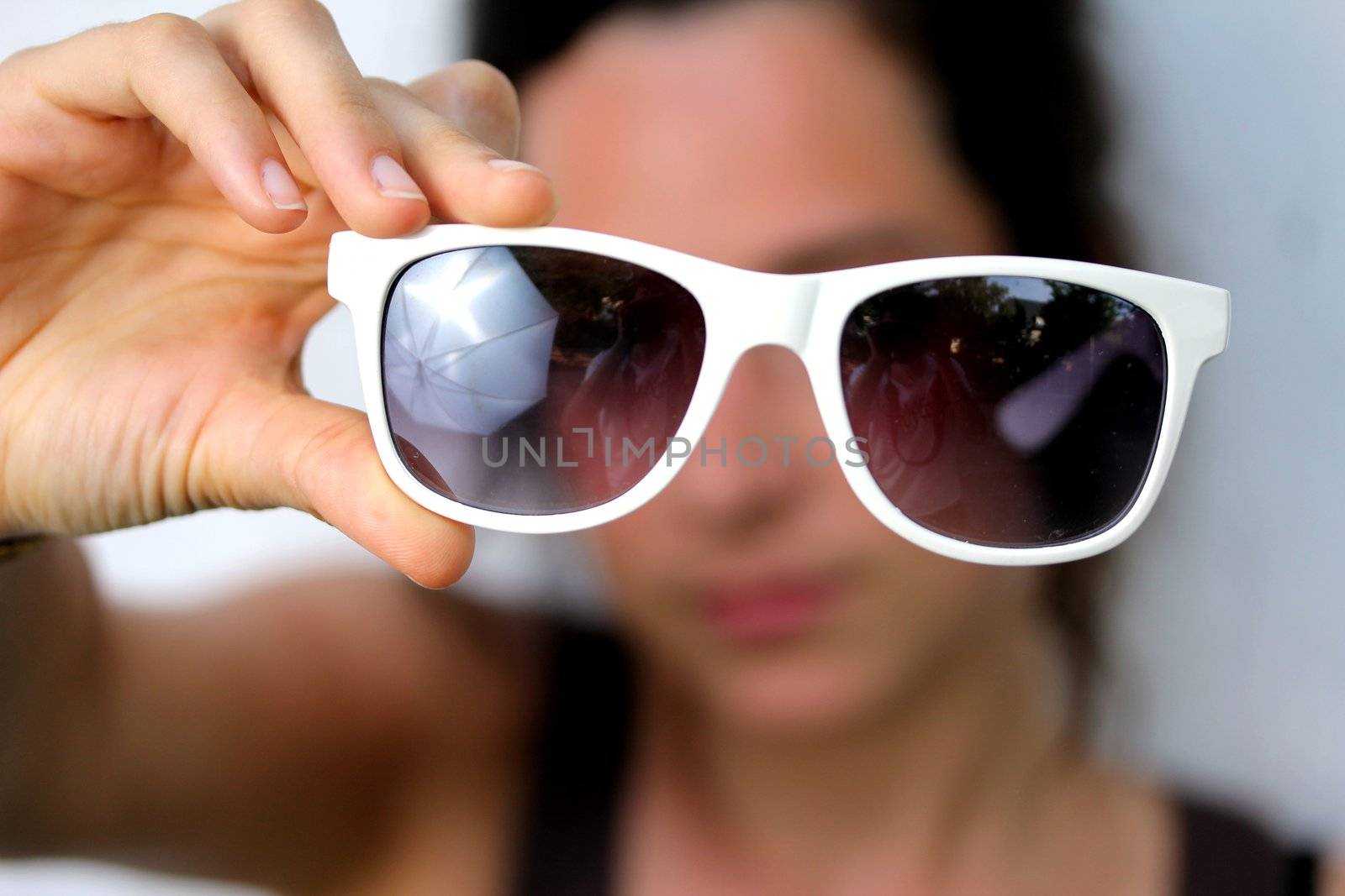 young woman holding sunglasses by Teka77