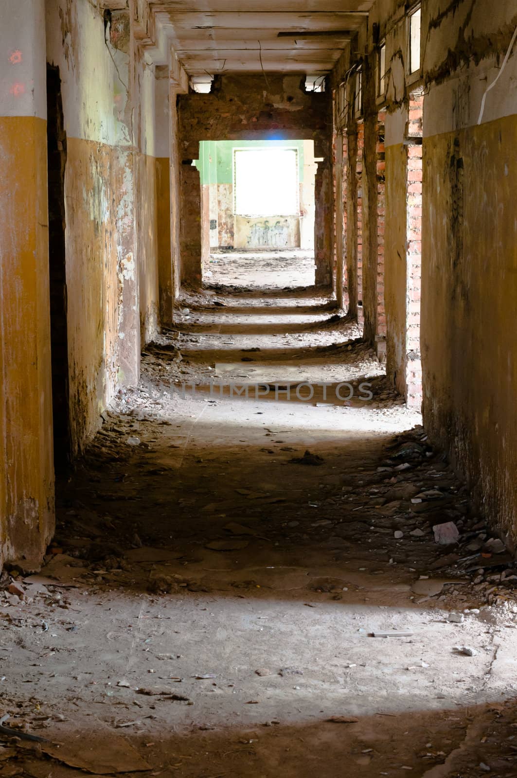 Old and abandoned corridor with shadows rhythm on the flour