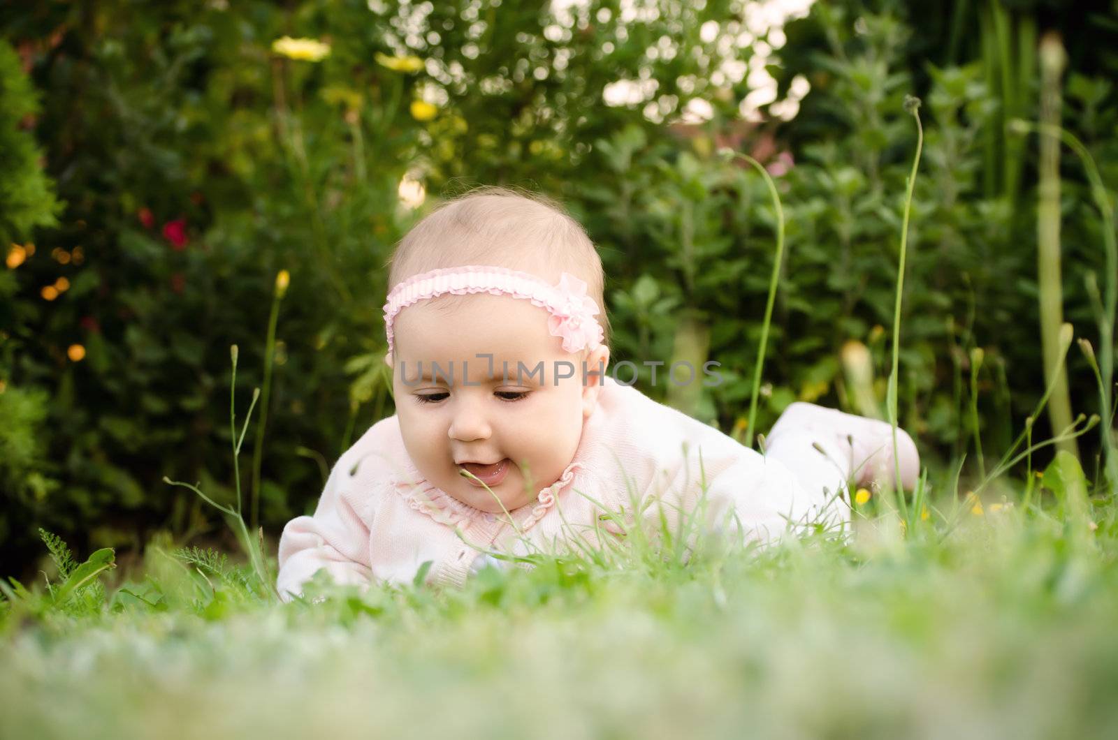 Bird's eye view shoot of a baby girl sitting in the grass