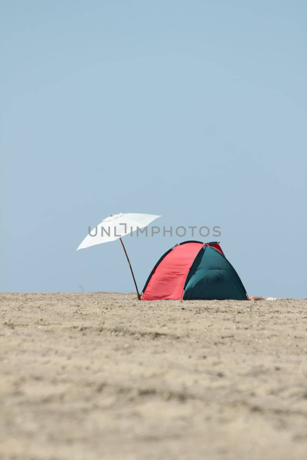 lonely parasol and sun tent on the beach by Teka77