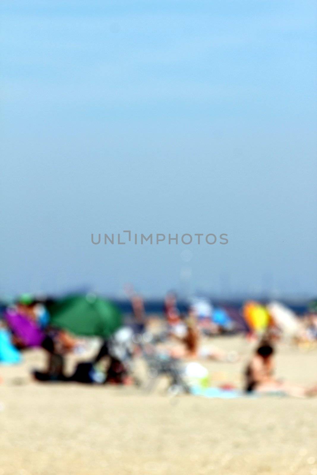 blur background : people relaxing on the beach by Teka77
