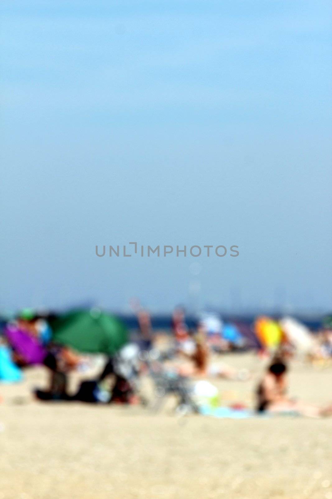 blur background : people relaxing on the beach