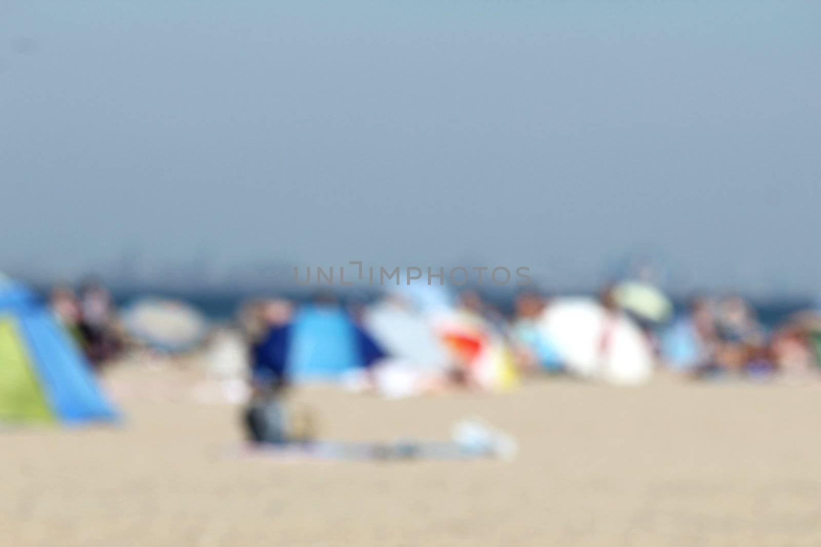 blur background : people relaxing on the beach by Teka77