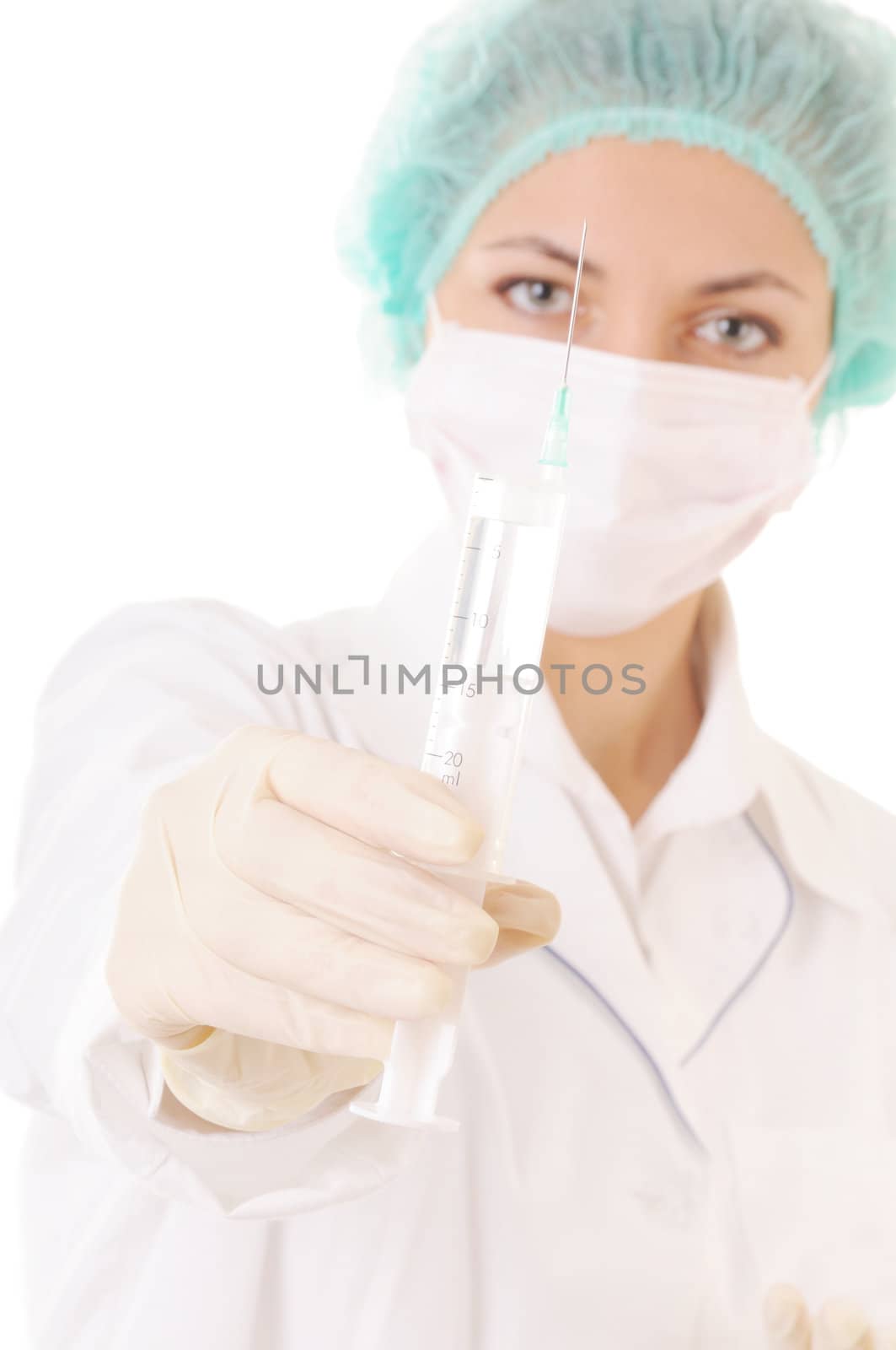 Doctor in mask and cap with syringe in hands isolated on white background. Focus on the syringe. 