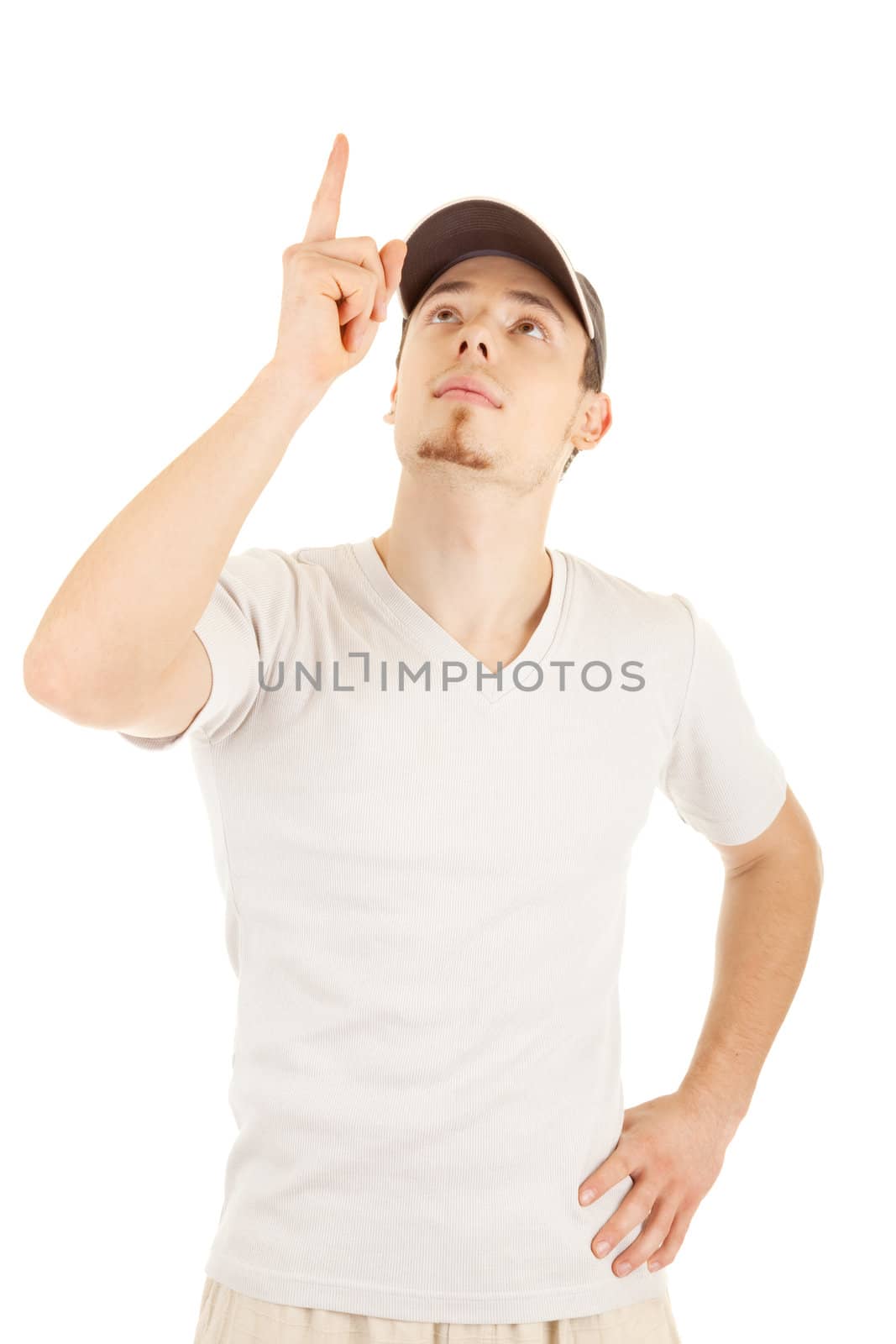 Casual young man in a hat is pointing and looking up. Isolated on white.