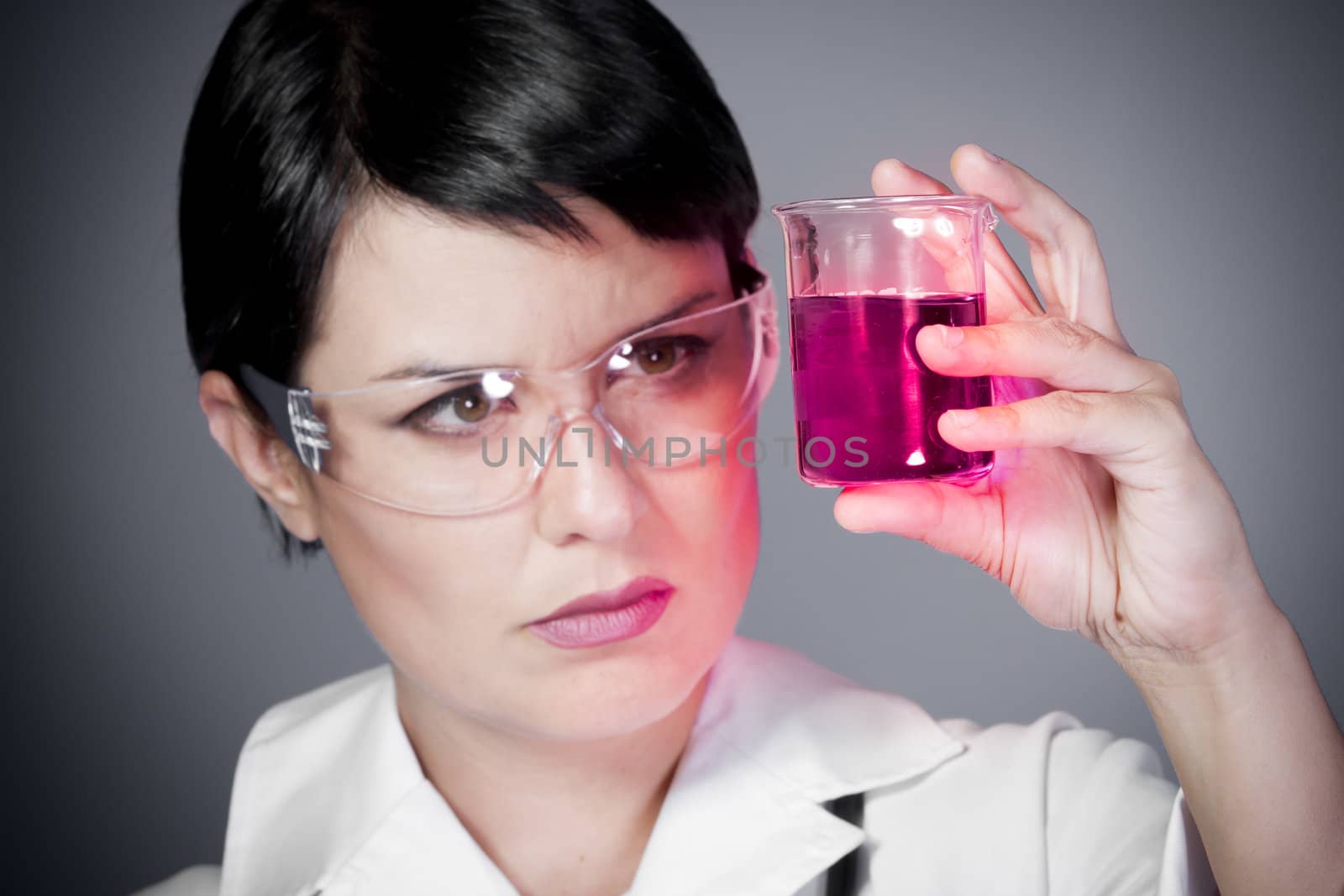 young brunette female doctor checking laboratory samples with protective glasses, career women, research