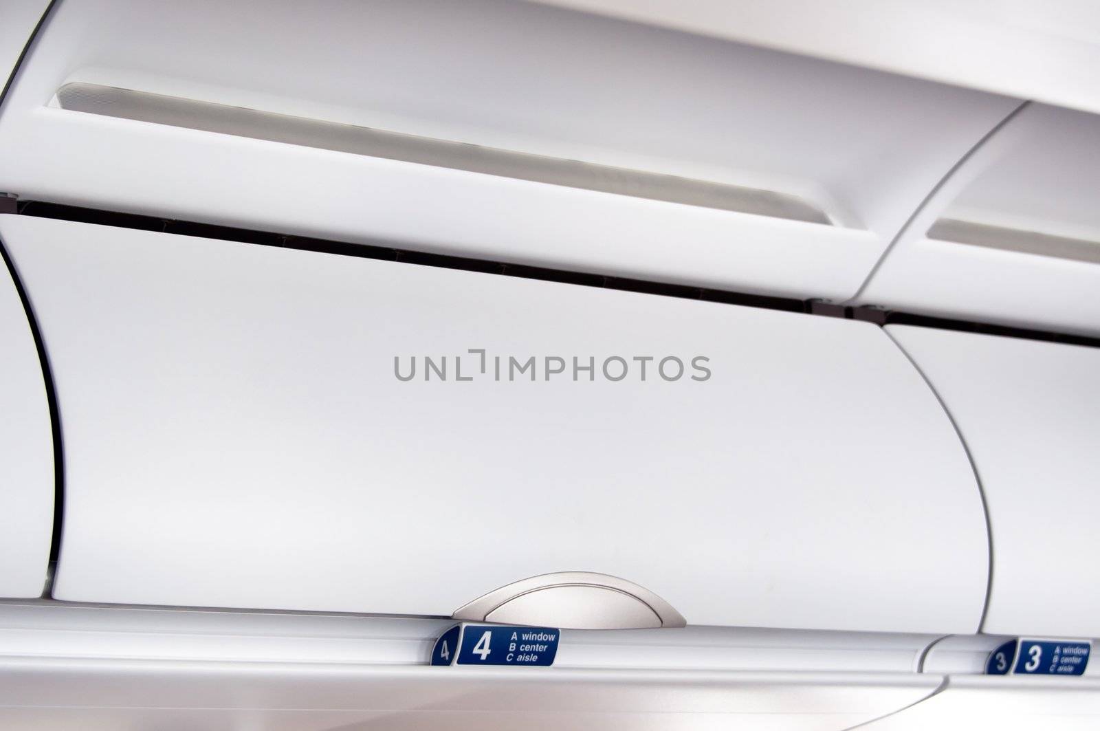Overhead compartment - detail shot of an airplane cabin interior