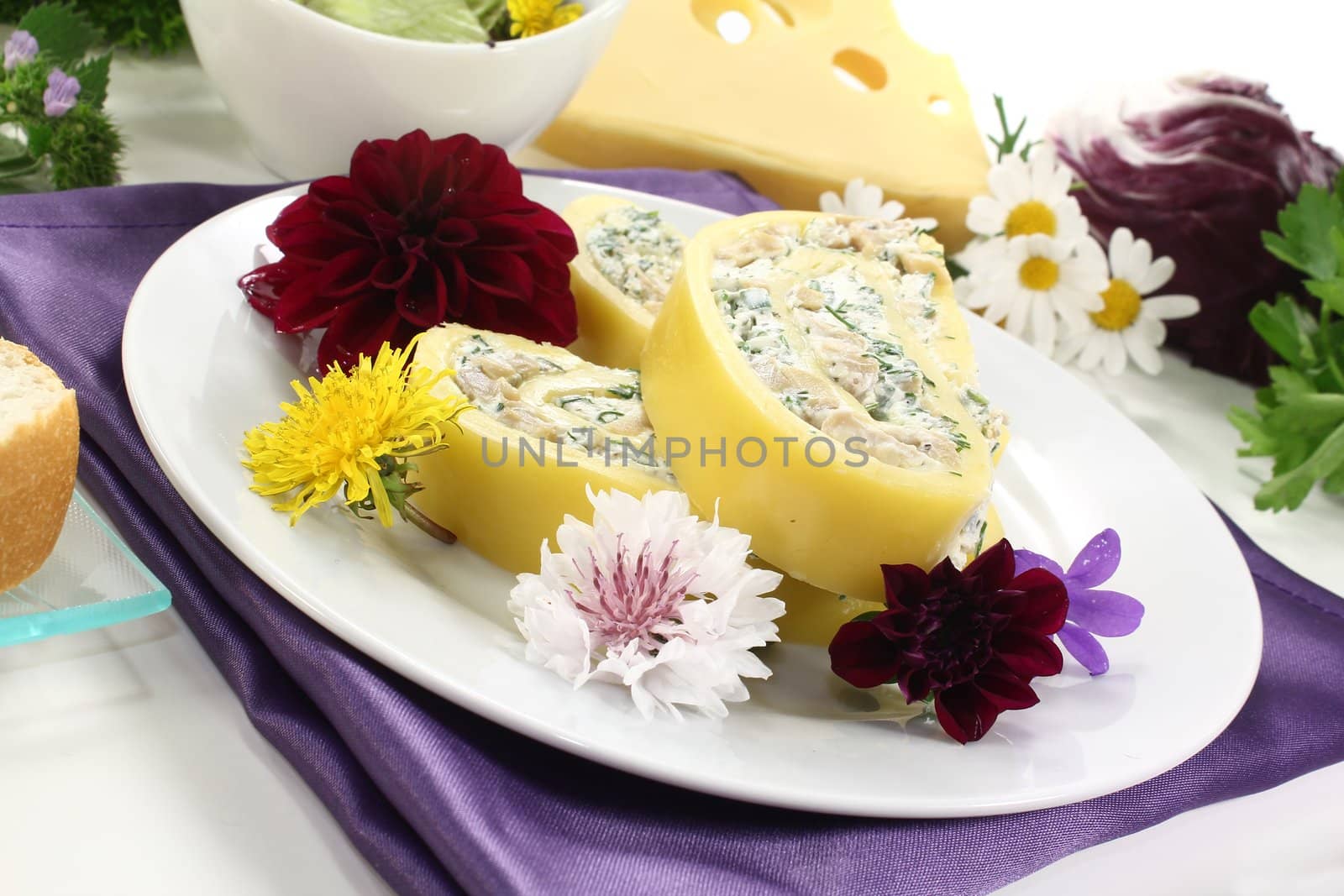 delicious stuffed cheese rolls with cream cheese and herbs on a light background