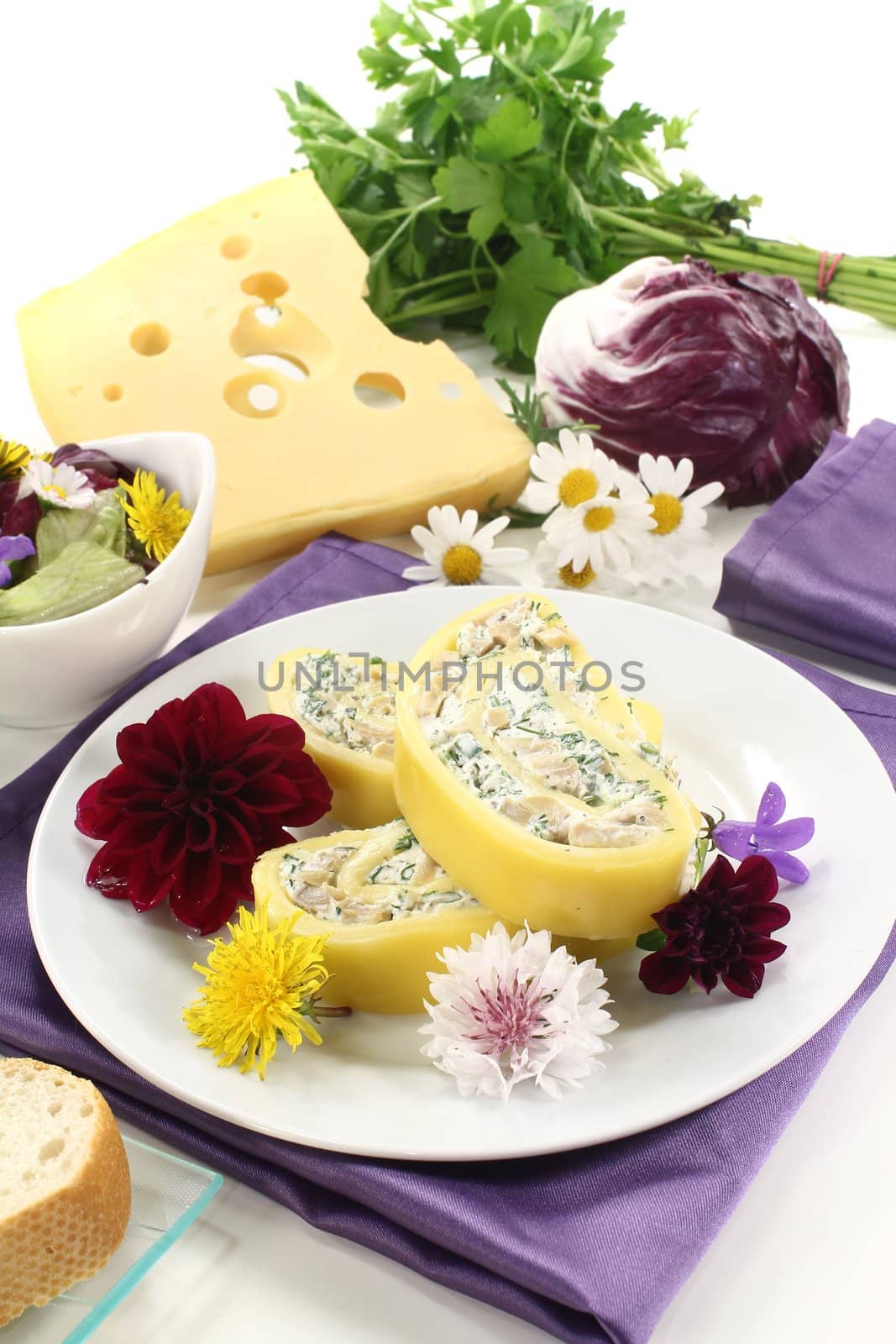 stuffed cheese rolls with cream cheese and herbs on a light background