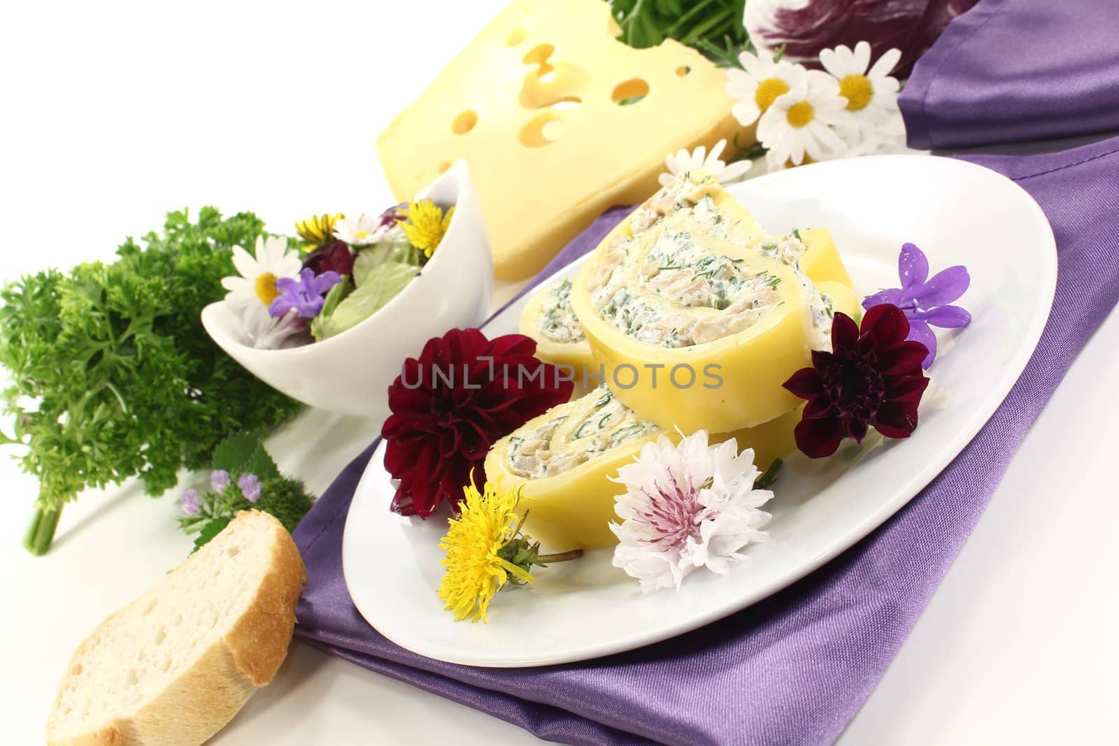 fresh stuffed cheese rolls with cream cheese and herbs on a light background