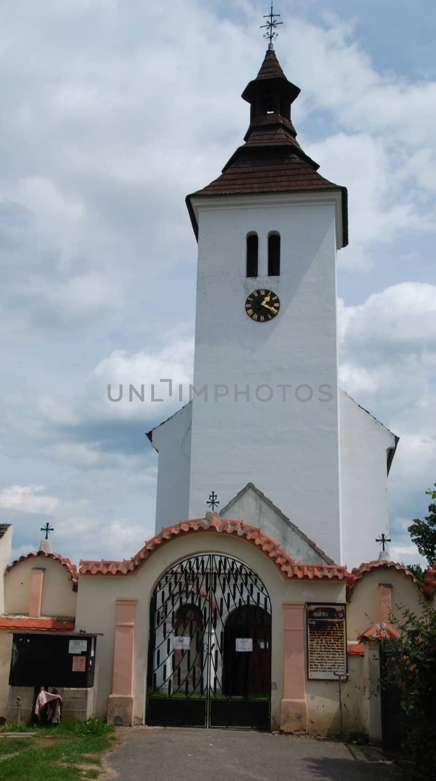 Old Czech church in the country with a graveyard