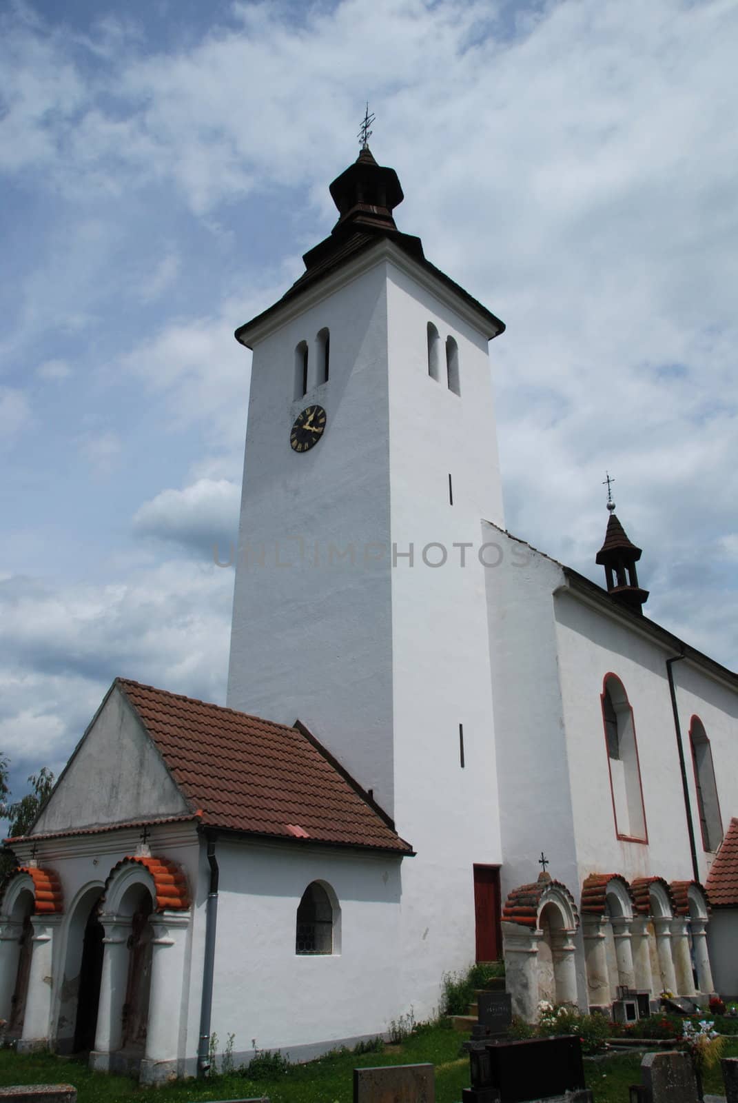 Old Czech church in the country with a graveyard