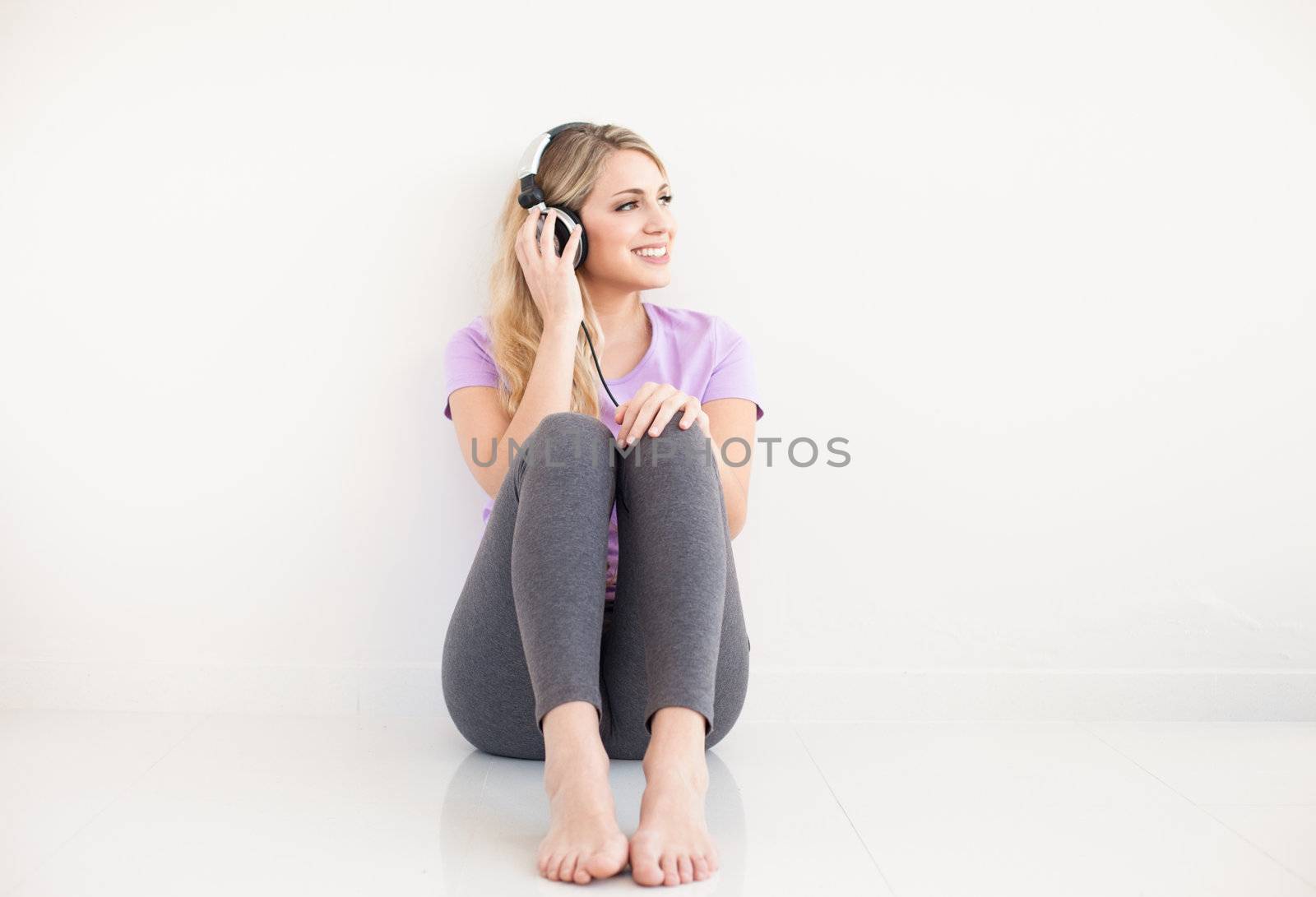 young beautiful woman listen music with headphones by Lcrespi