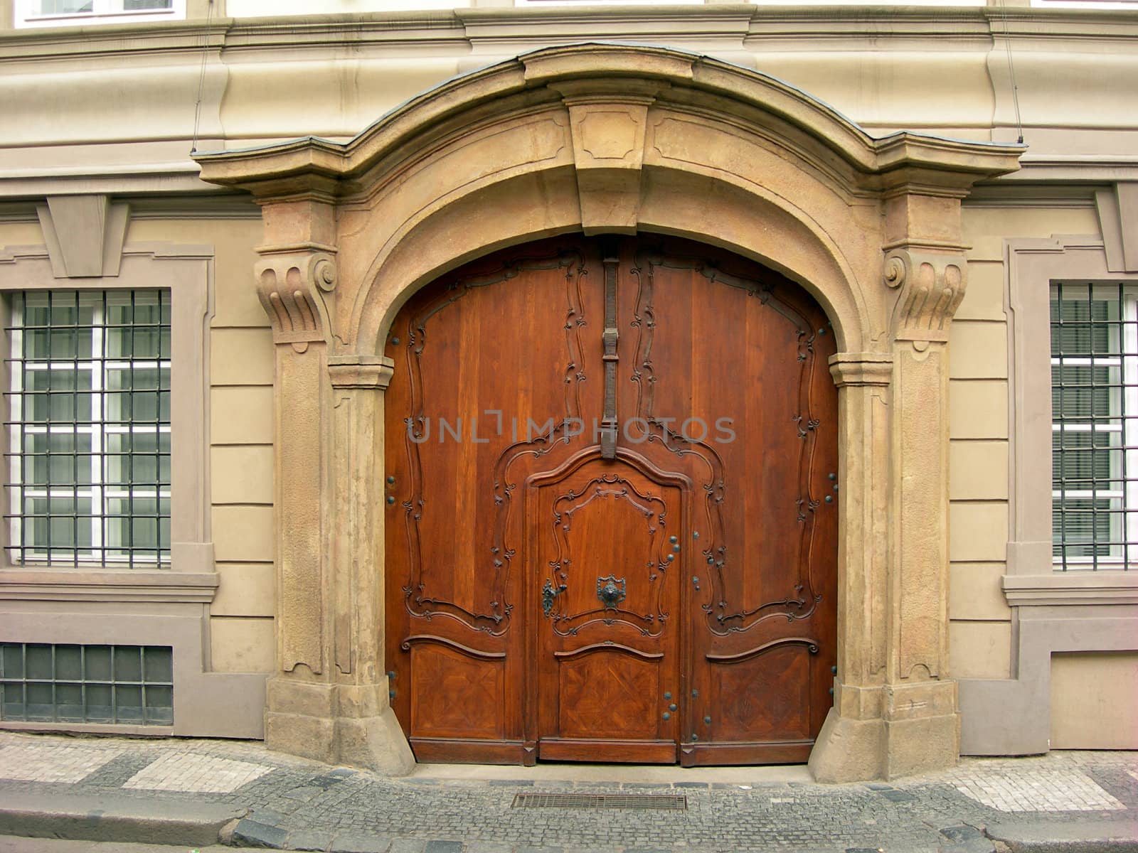           Old wooden portal of  in Prague with two pillars on a side