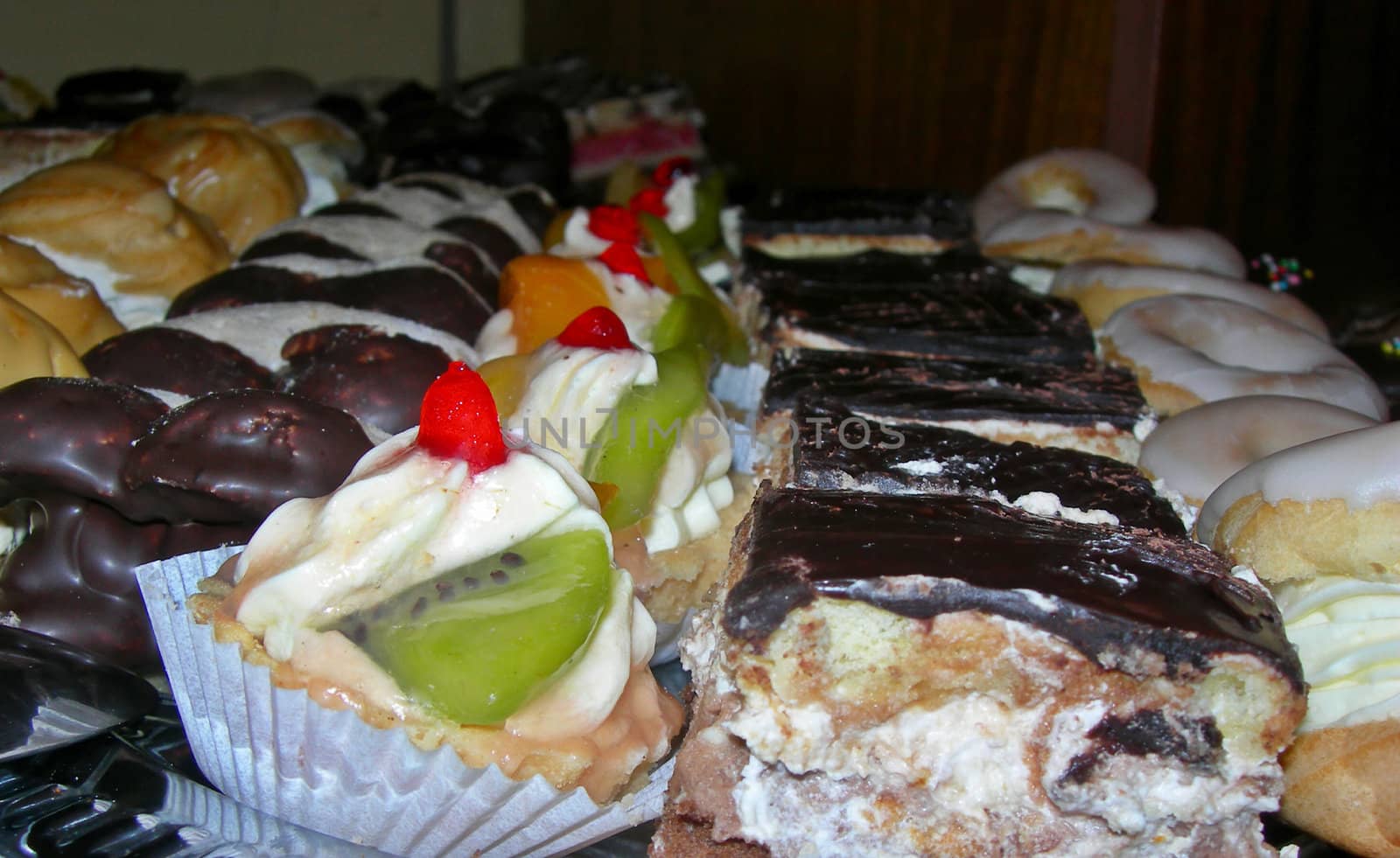 Variety of tasty desserts with cream and chocolate on a dish
