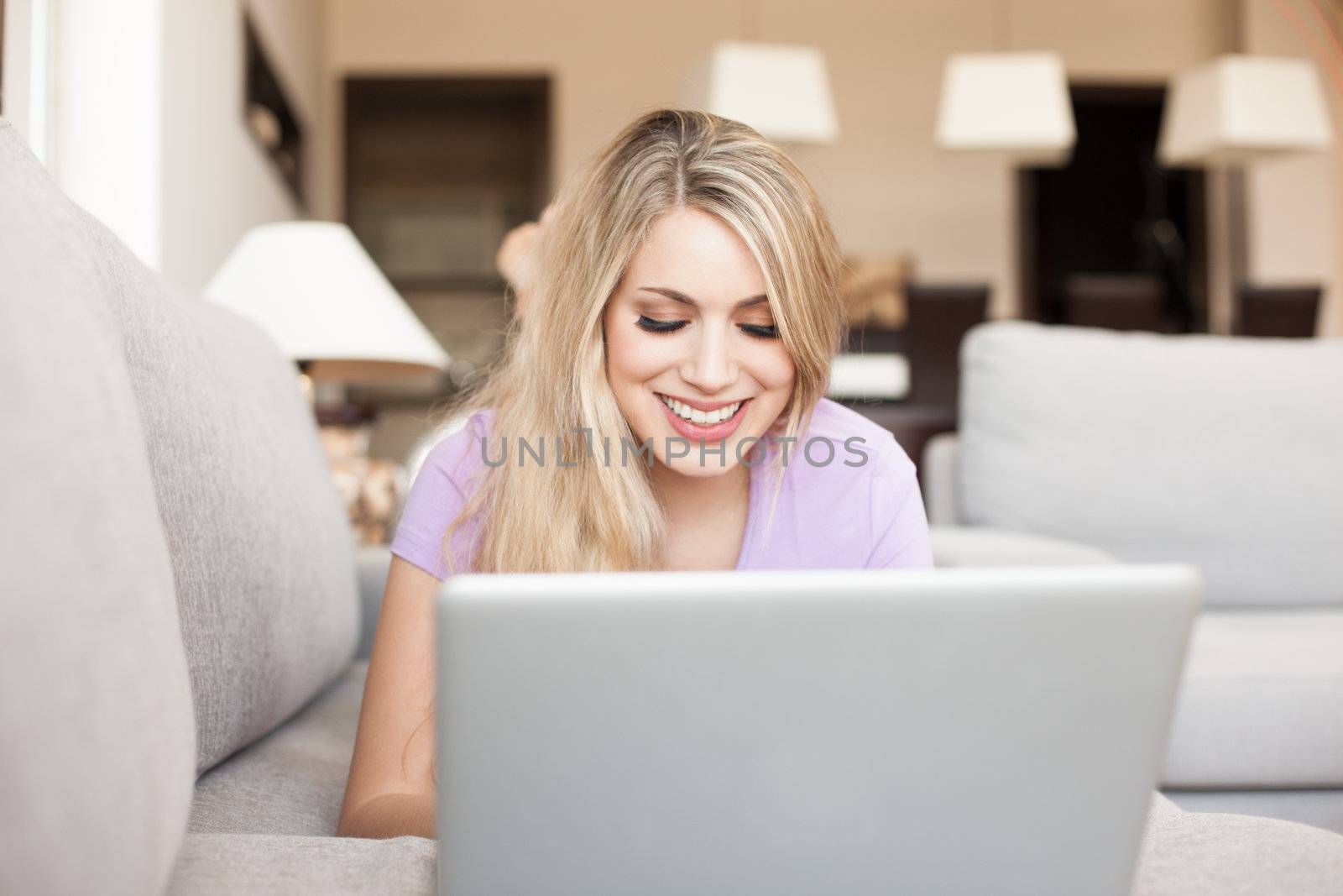 young beautiful woman using a laptop at home by Lcrespi