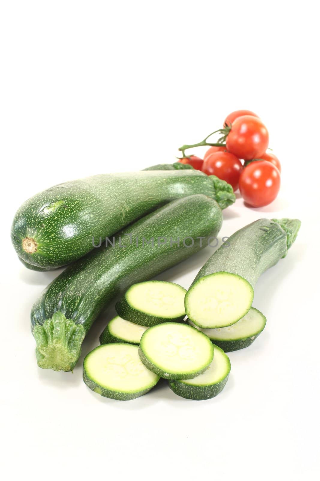 fresh zucchini with red tomatoes on a light background