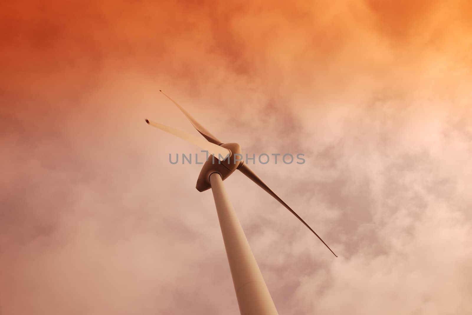 Wind turbine propeller and a sunset sky