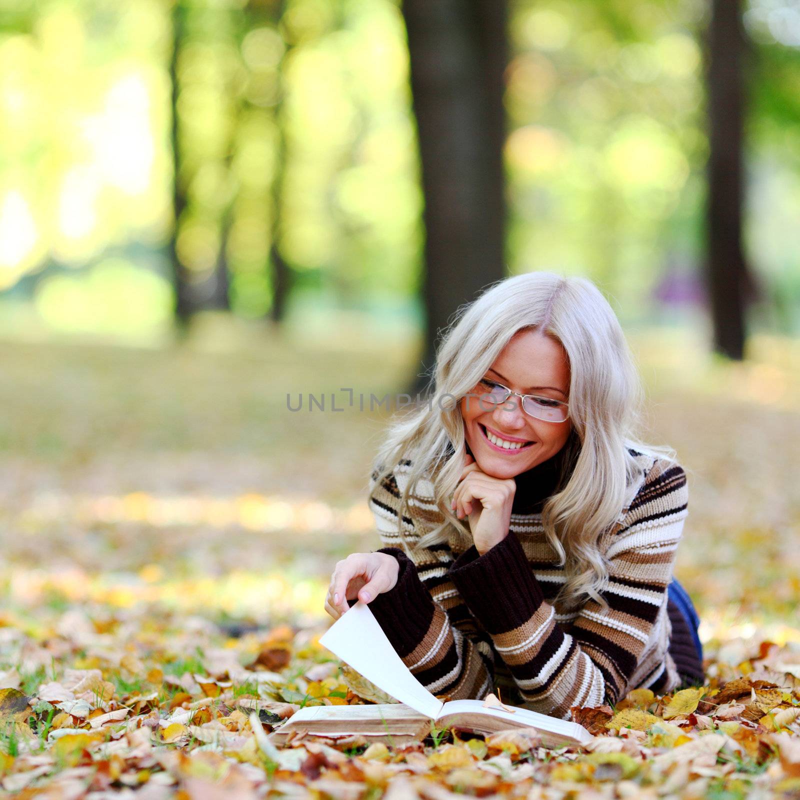 woman reading in autumn forest