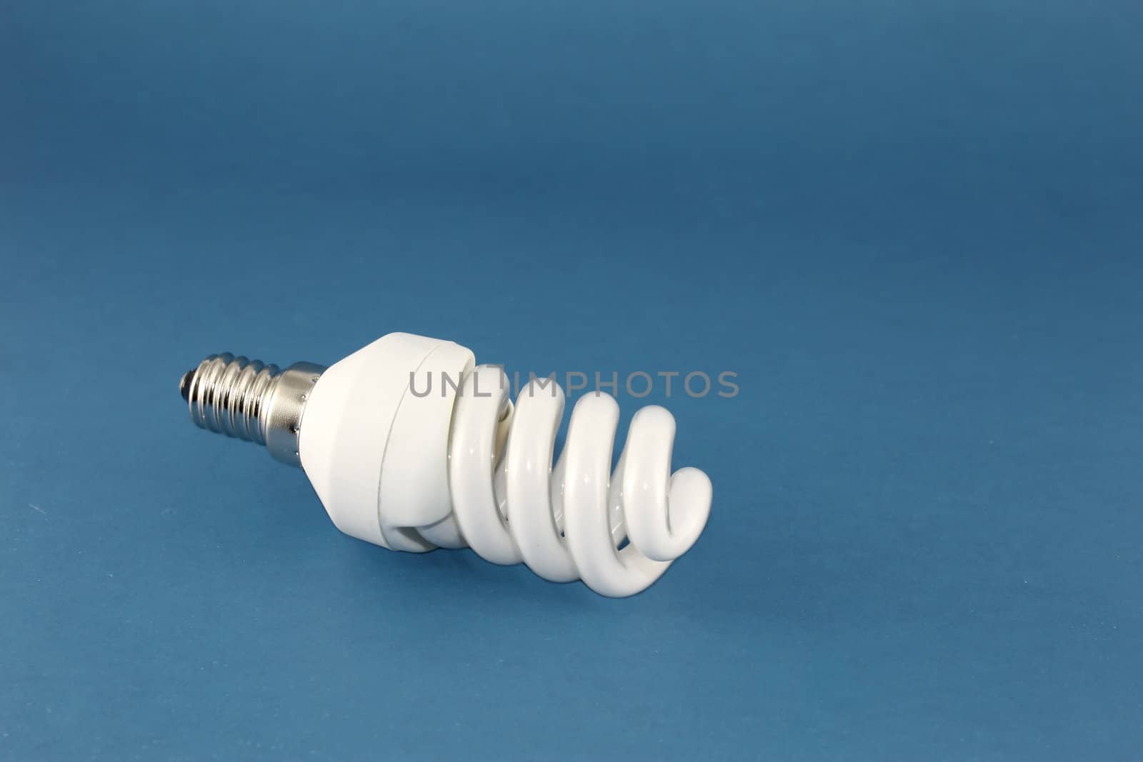 Energy conscious bulb lamp over blue