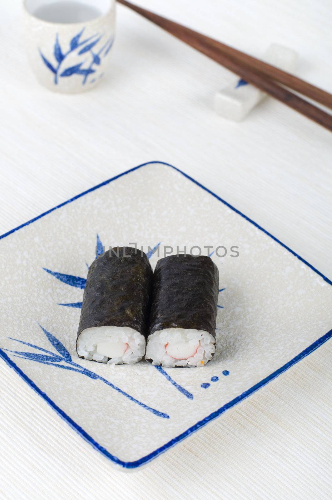 sushi on a plate with chopstick and tea cup by yuliang11