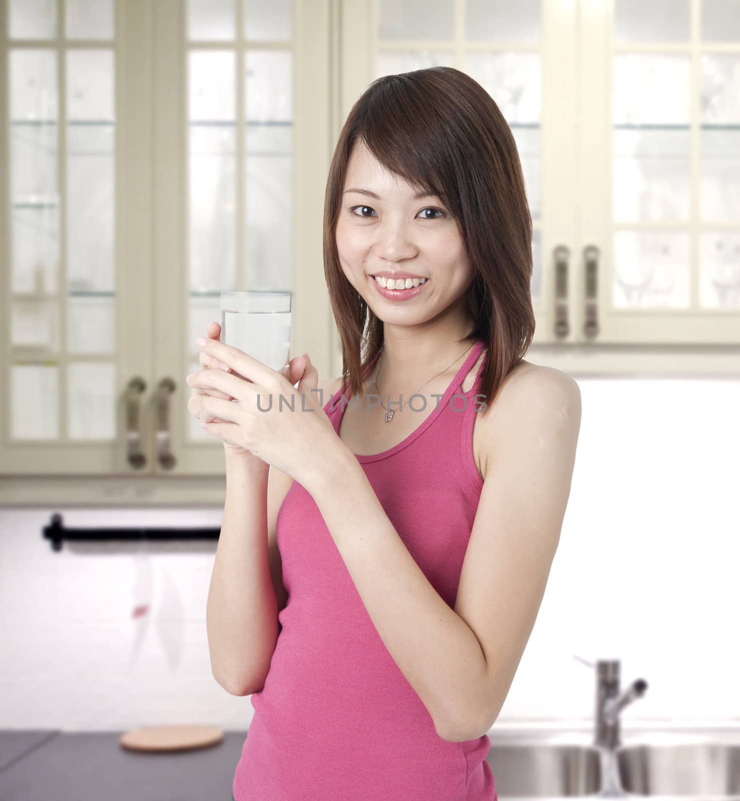 asian girl holding a glass of water