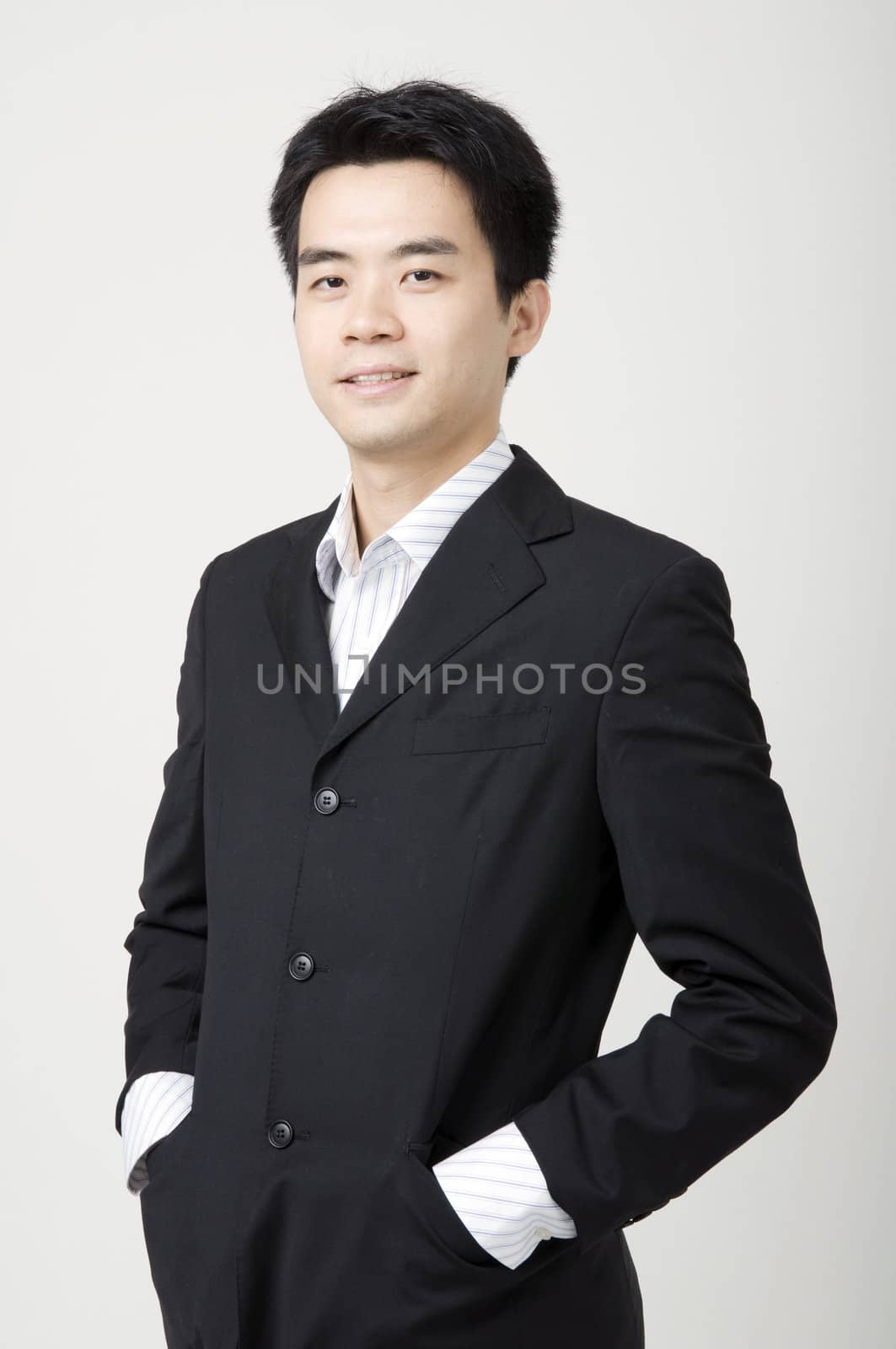 a happy looking young asian business man 