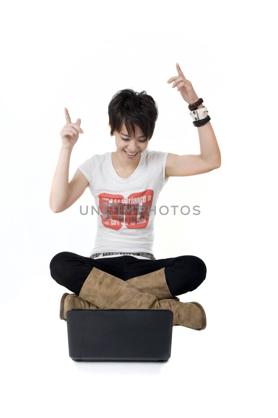 young cool looking asian female using a laptop on floor