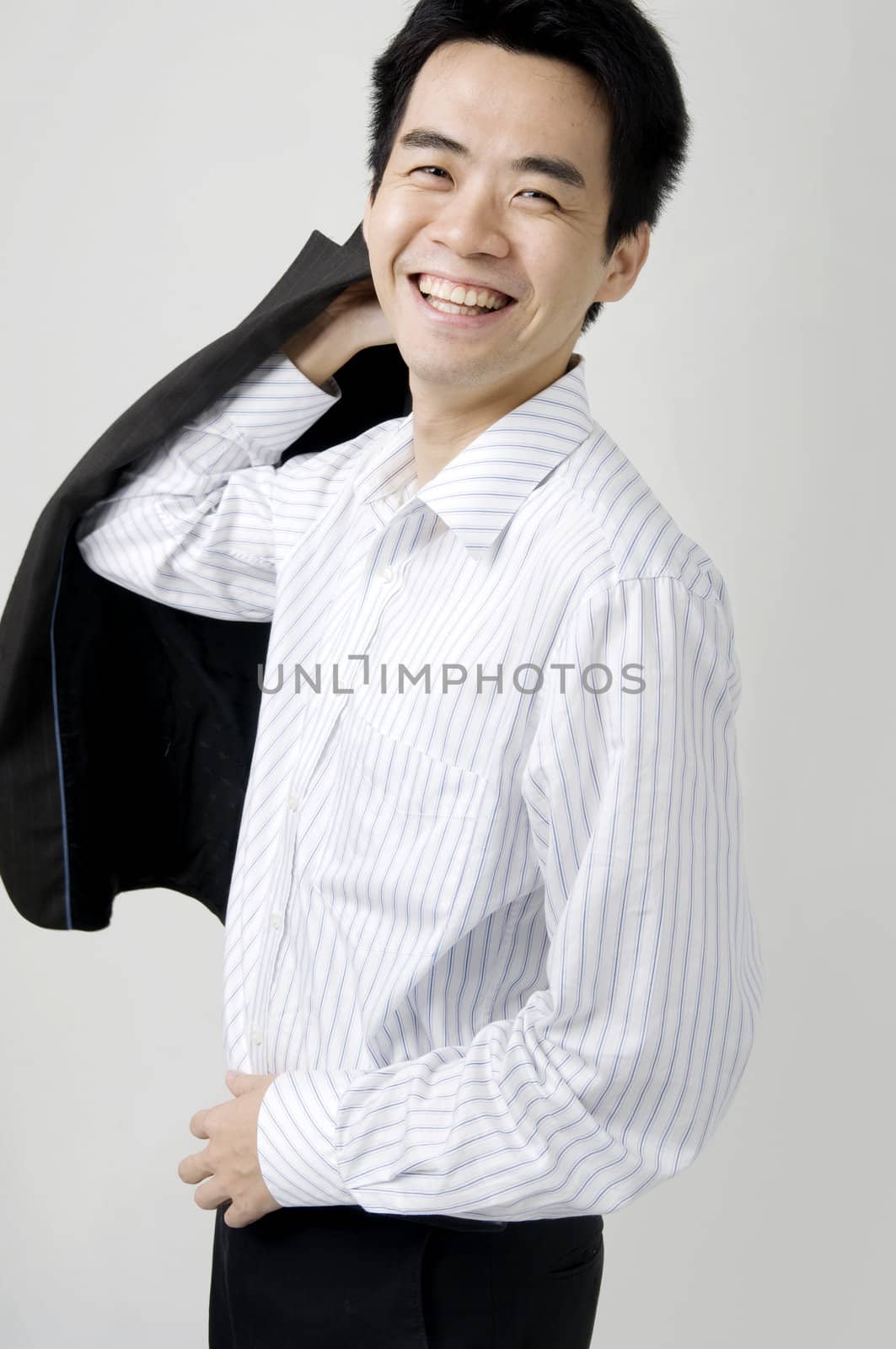 young asian business man smiling with a coat 