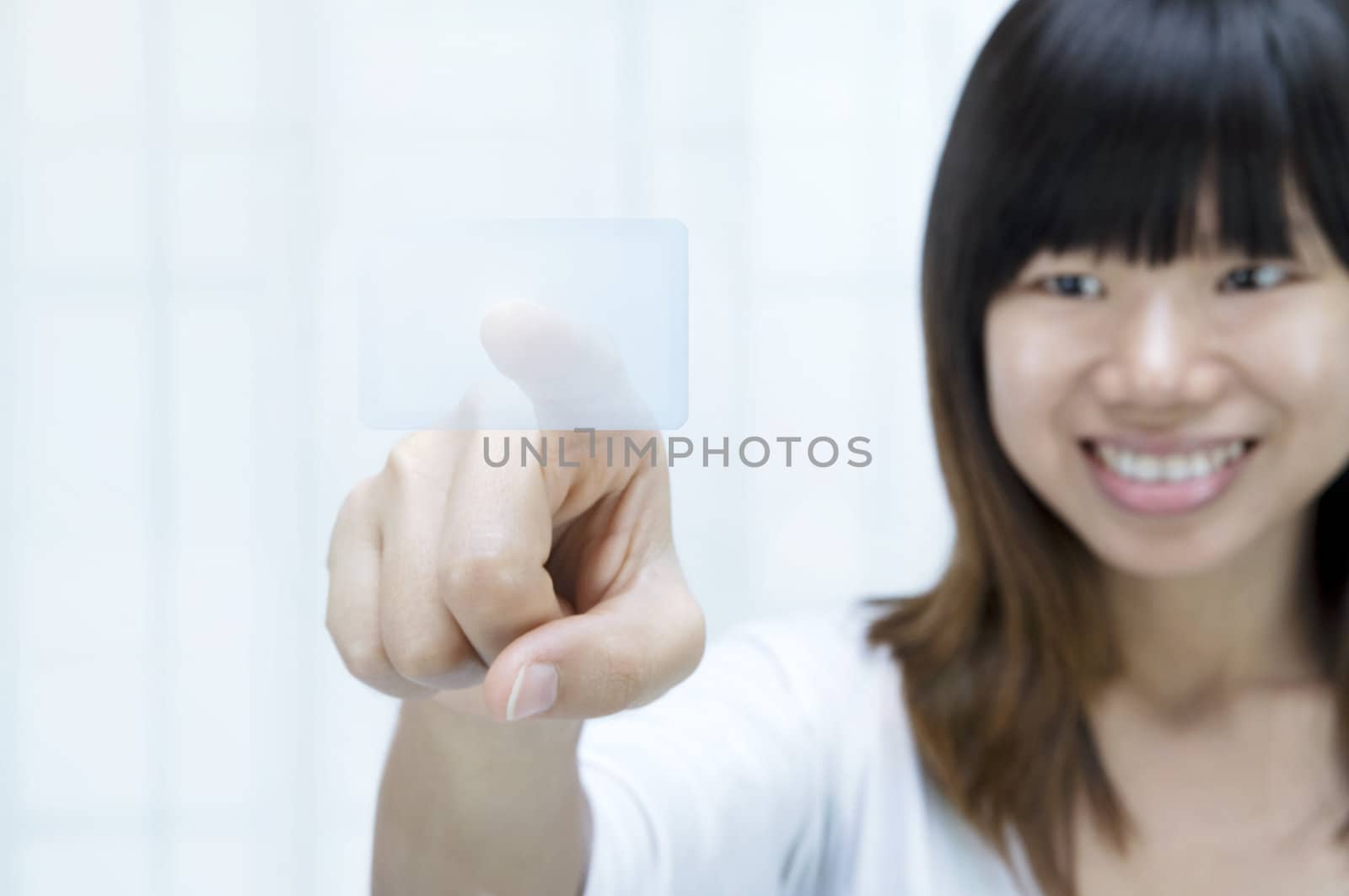 asian women smiling on a  touch screen