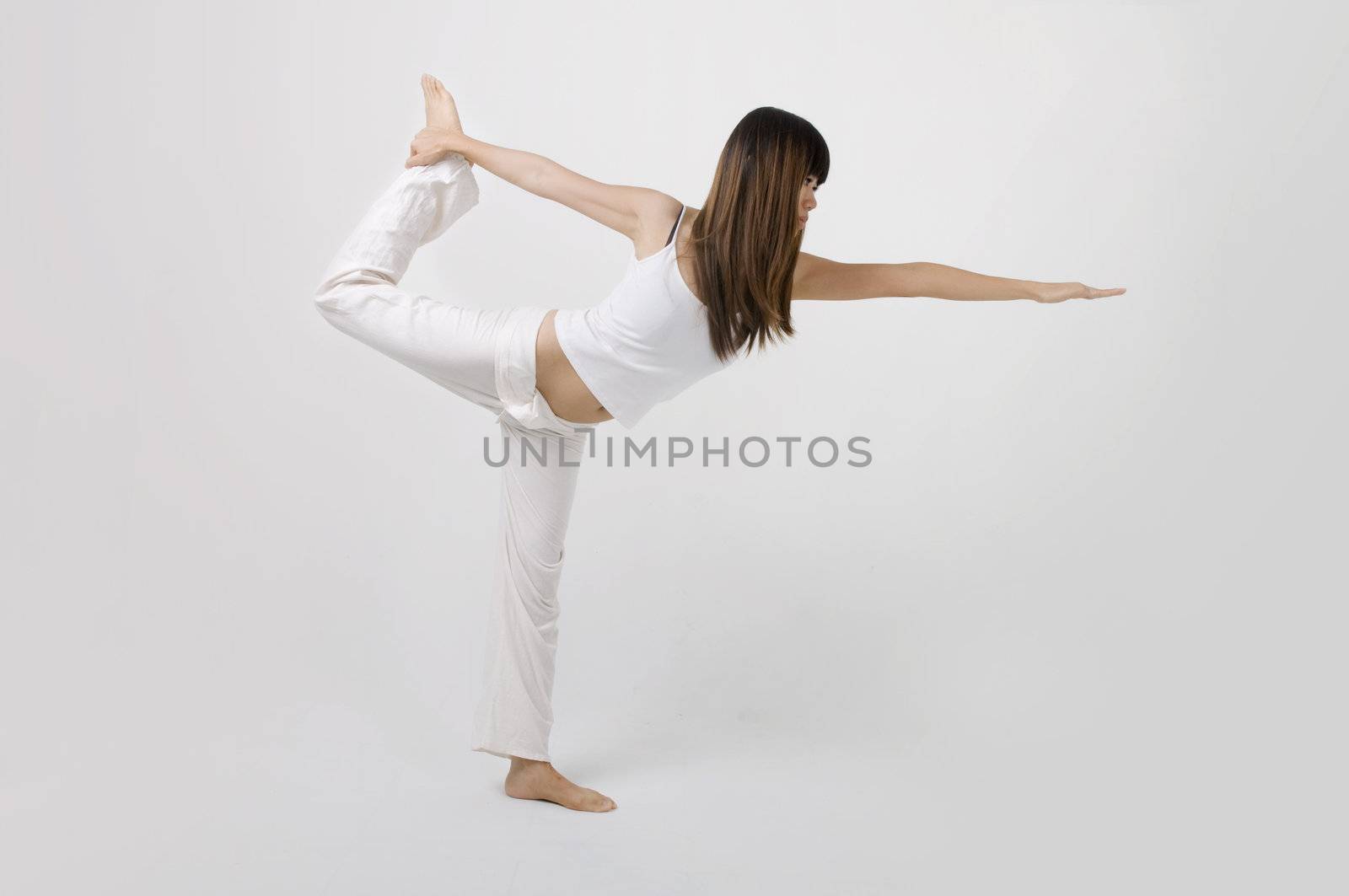 asian girl performing yoga in a studio 