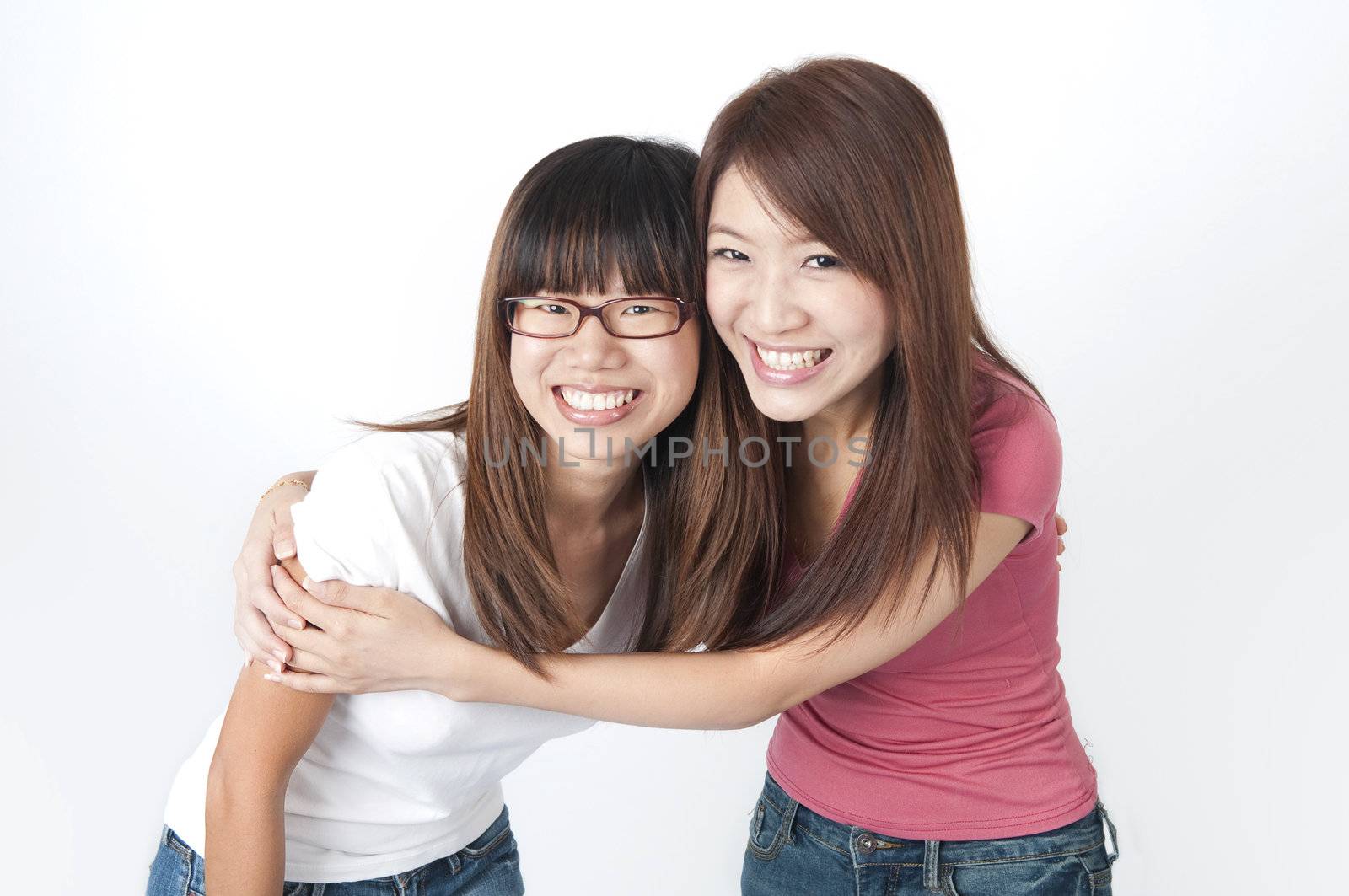 photo of two  asian girls having fun with
