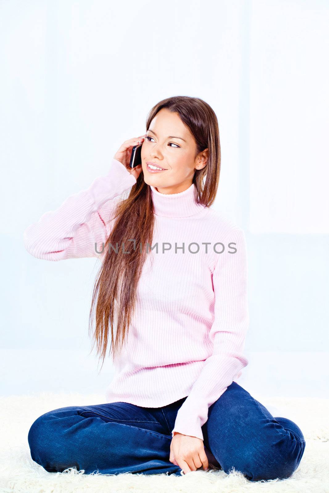 young woman talking on mobile phone at home
