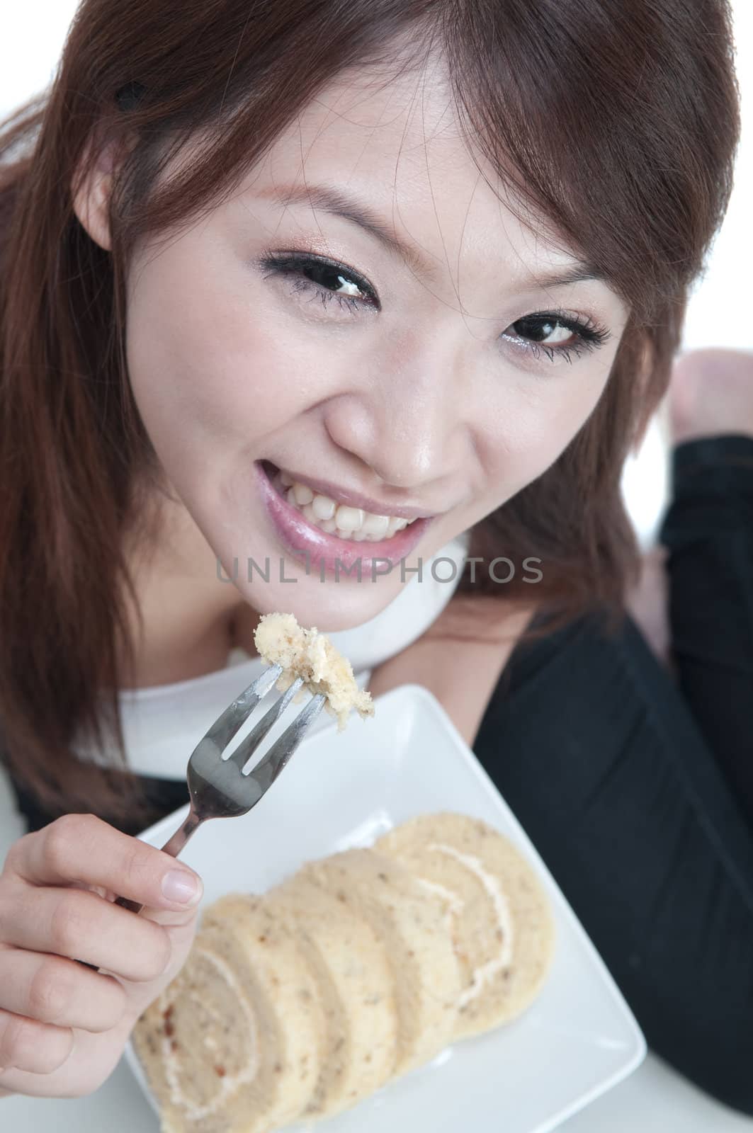 young asian woman enjoying cake 