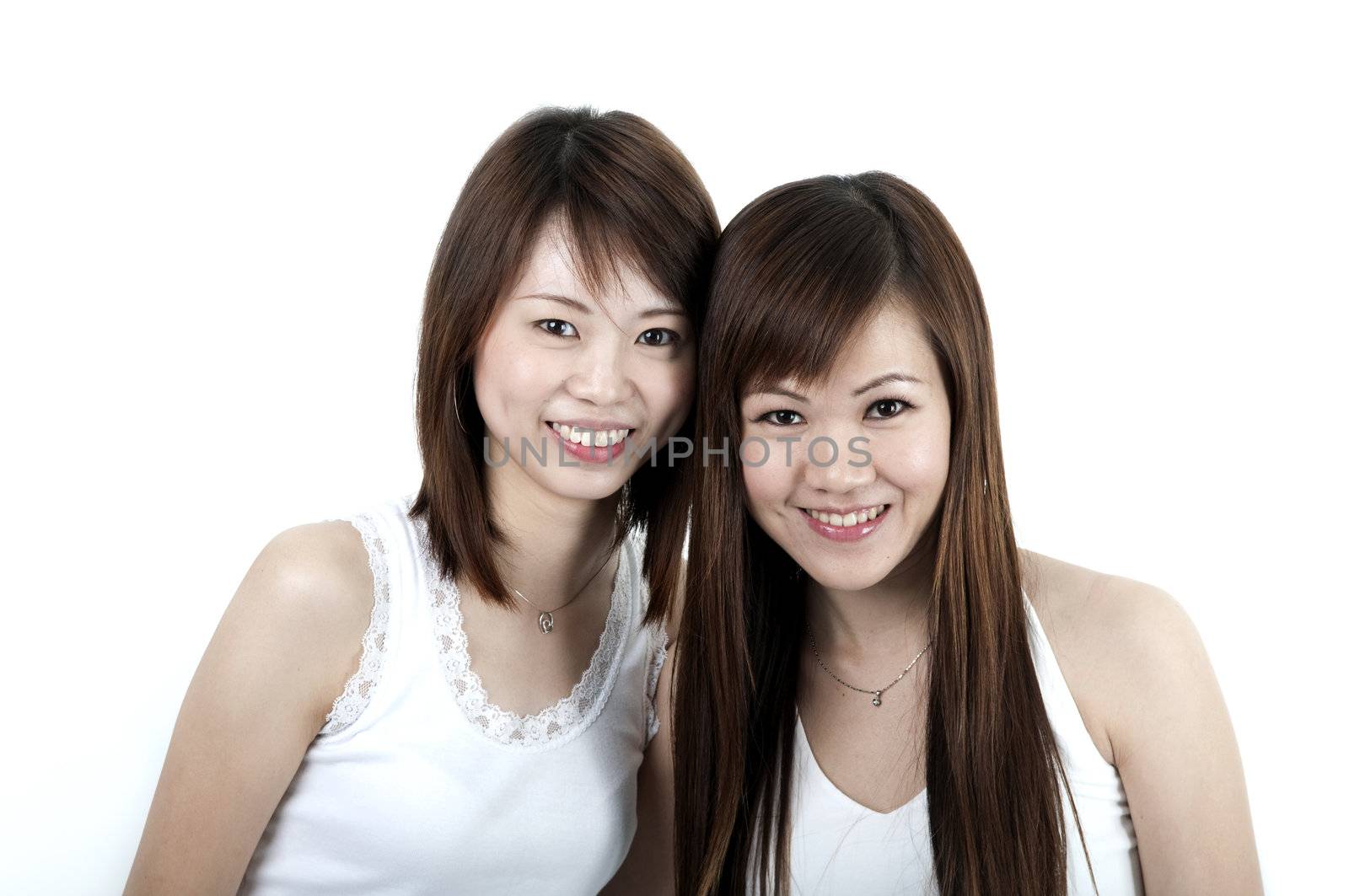 wo cheerful Asian girls isolated on white background.
