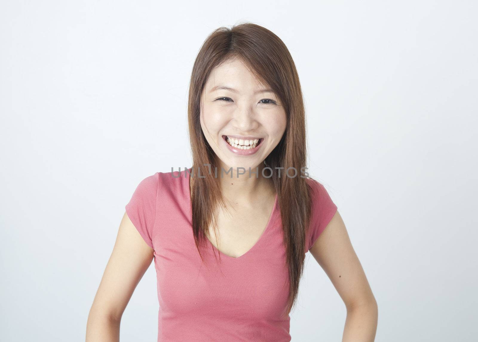 portrait of an asian girl laughing in joy 