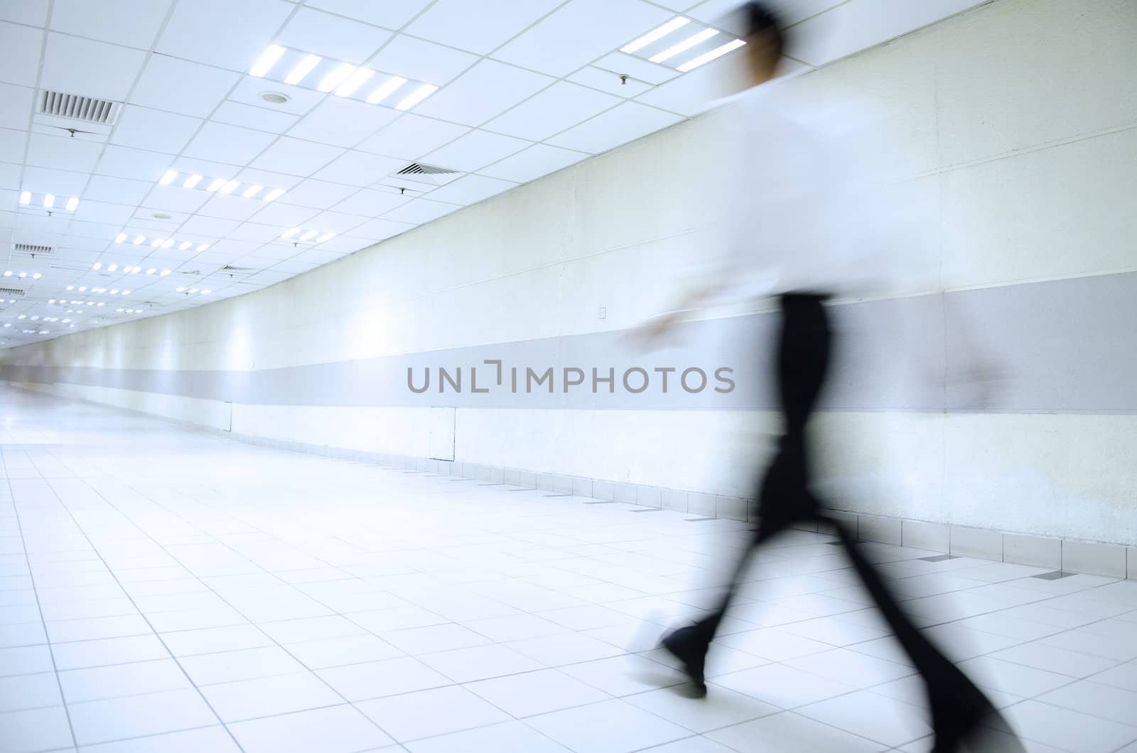 motion blur of people walking in blue tone 