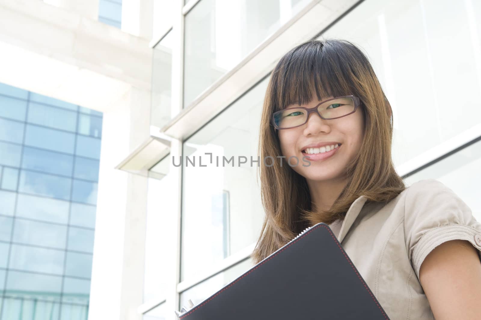 young asian business women holding a folder and smiling 
