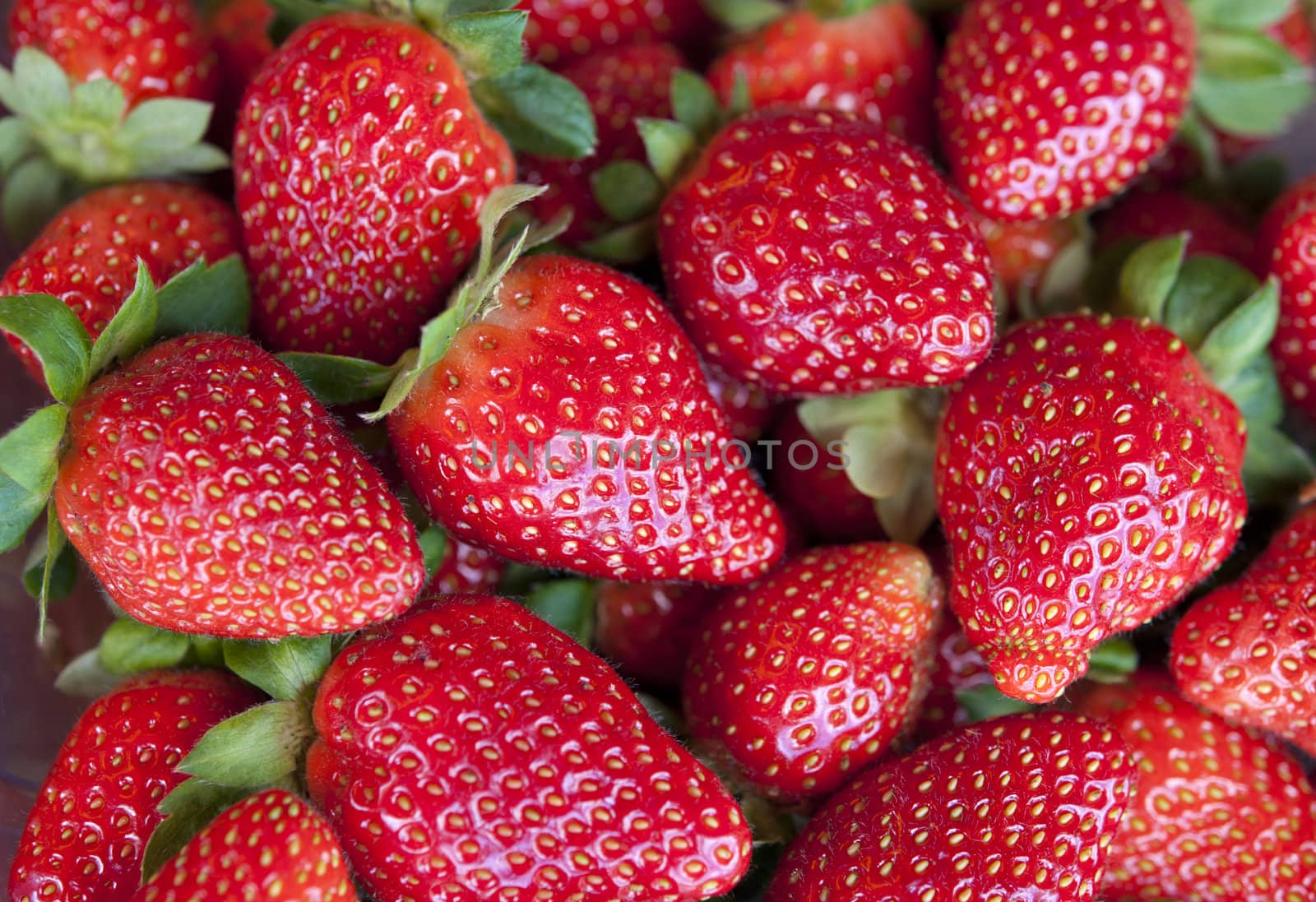 a group of strawberries for sale in the market