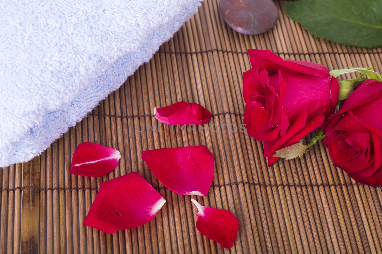 rose spa concept with towels and rocks
