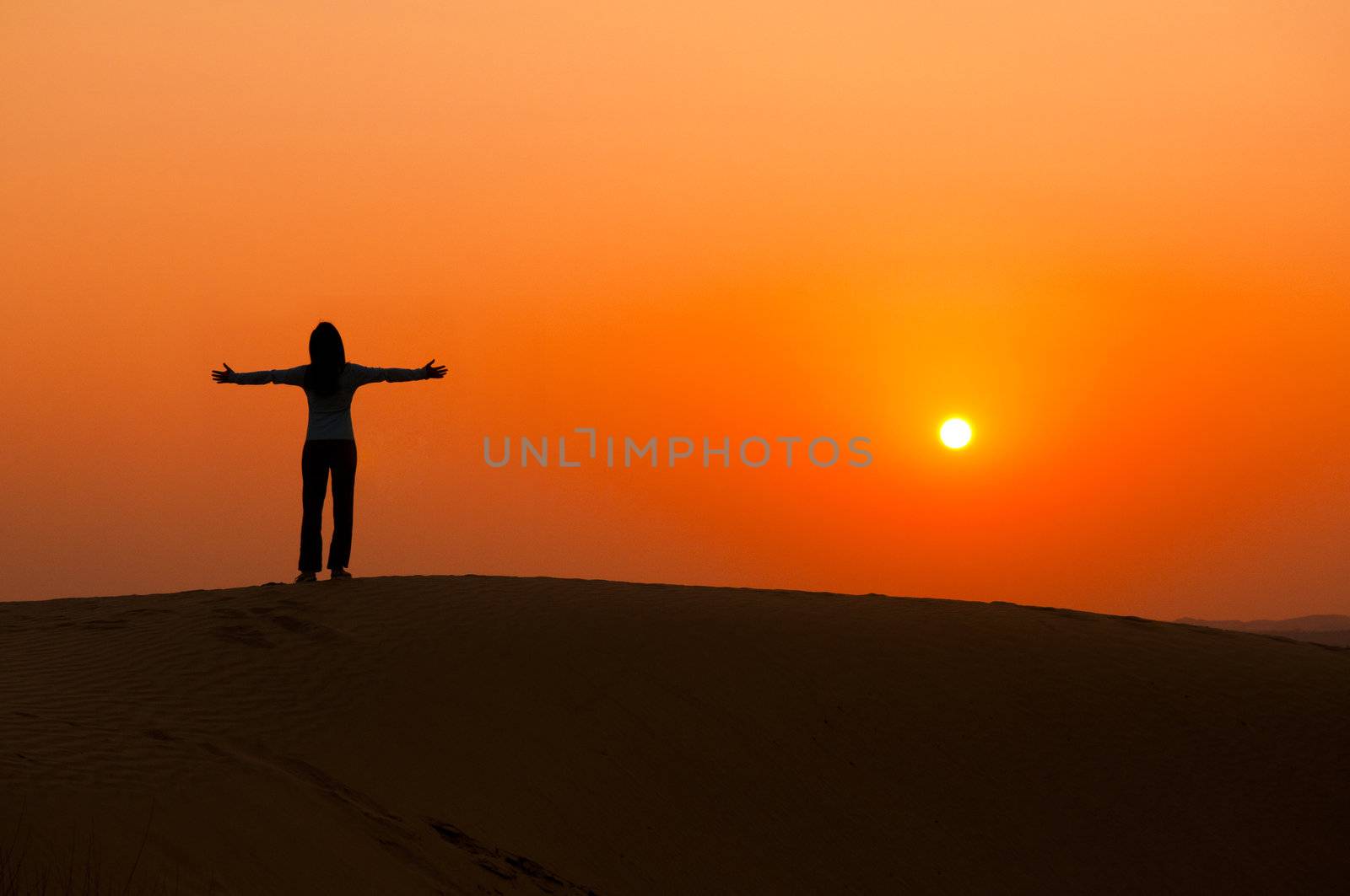 silhouette of a freedom girl on thar sam sand dune desert 