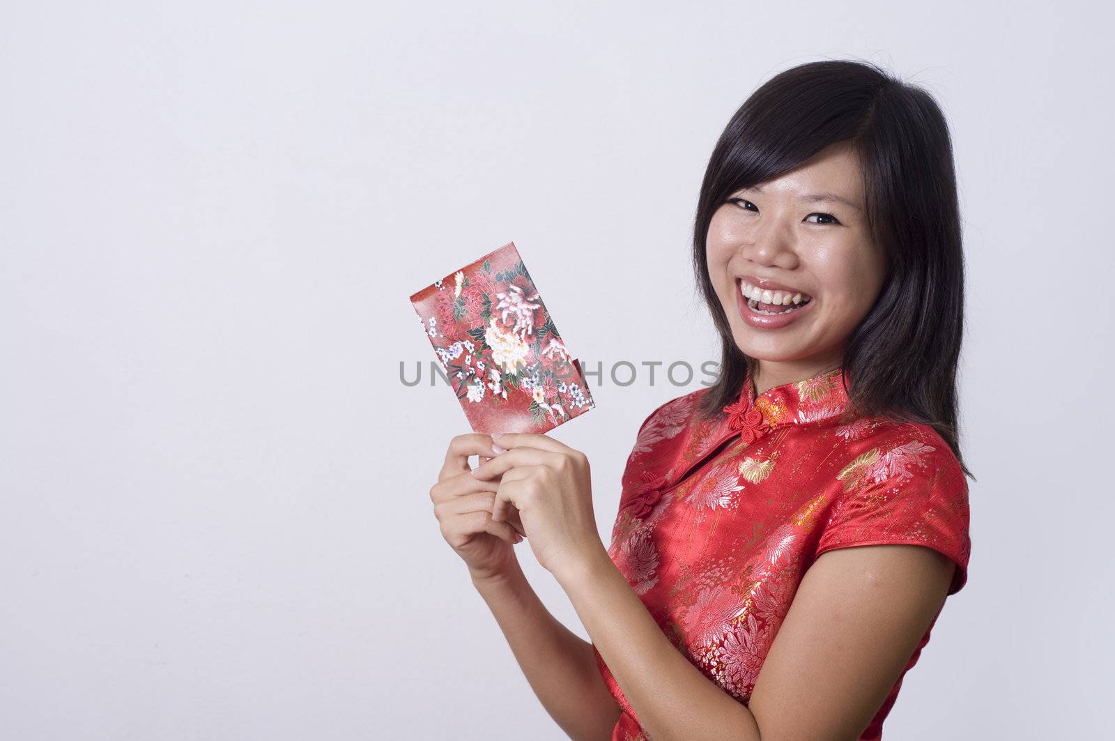 chinese new year girl holding a red packet with copyspace on right