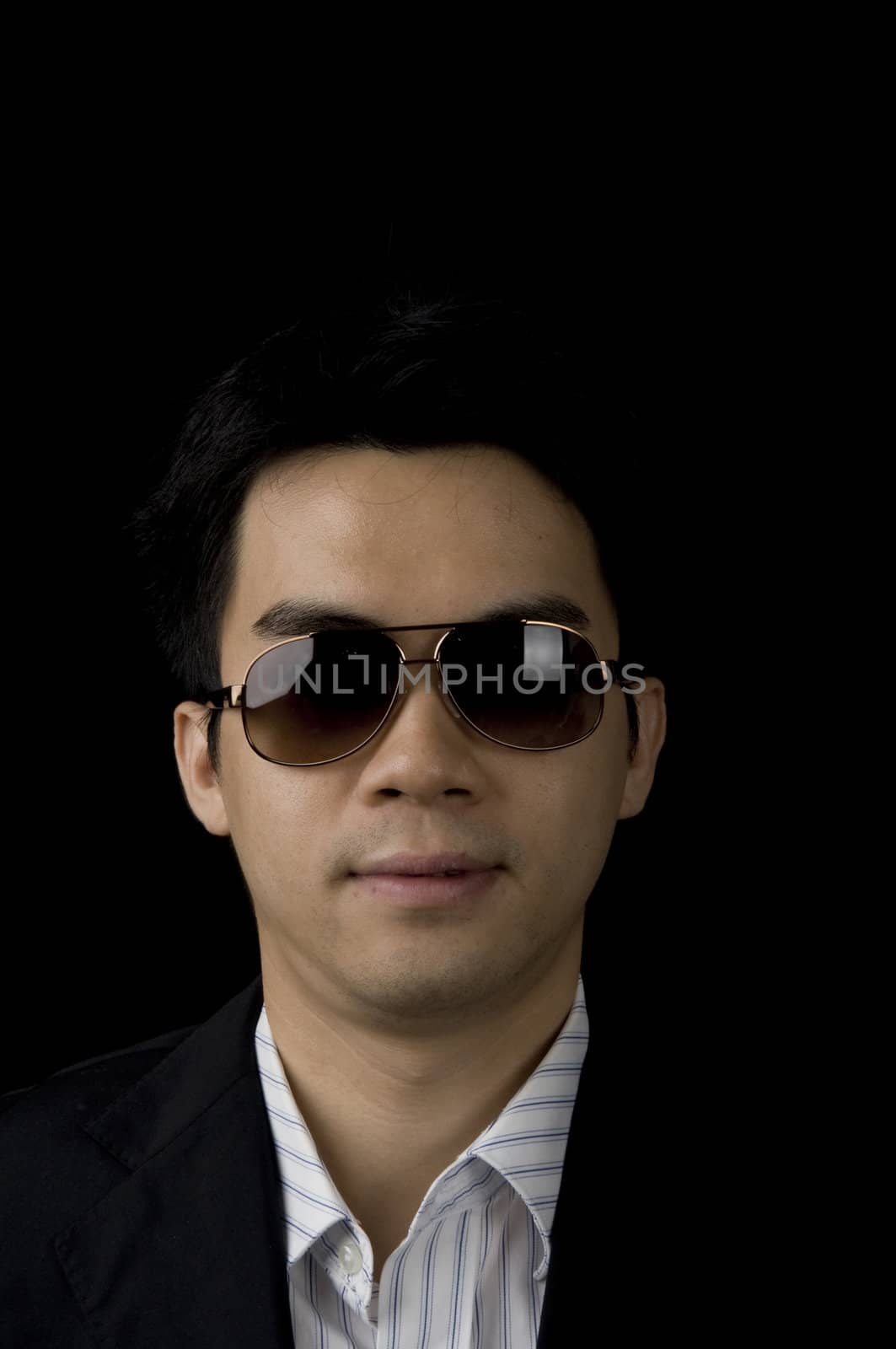 young asian businessman with dark glasses and black background