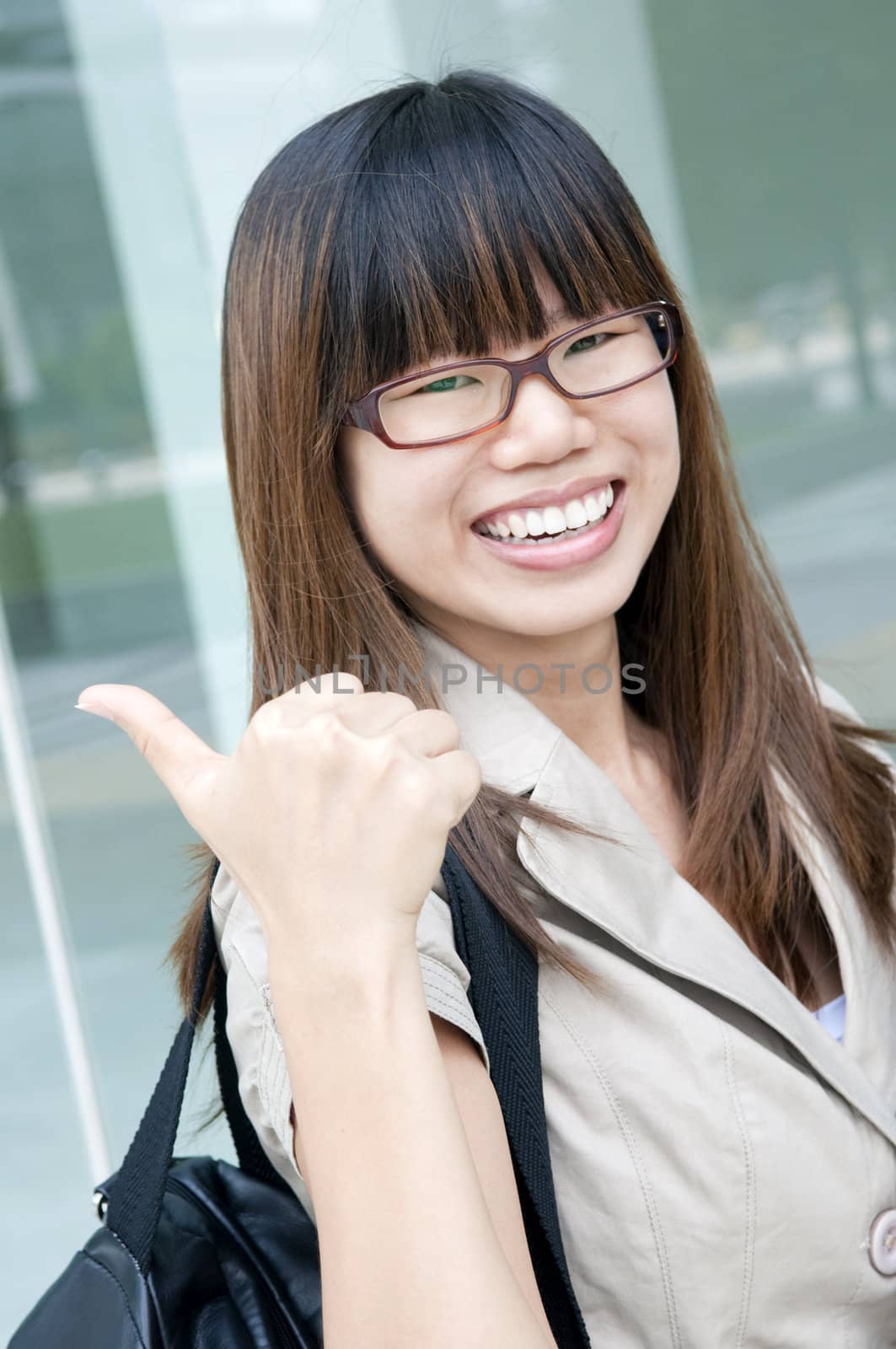 happy asian business women with laptop and thumbs up