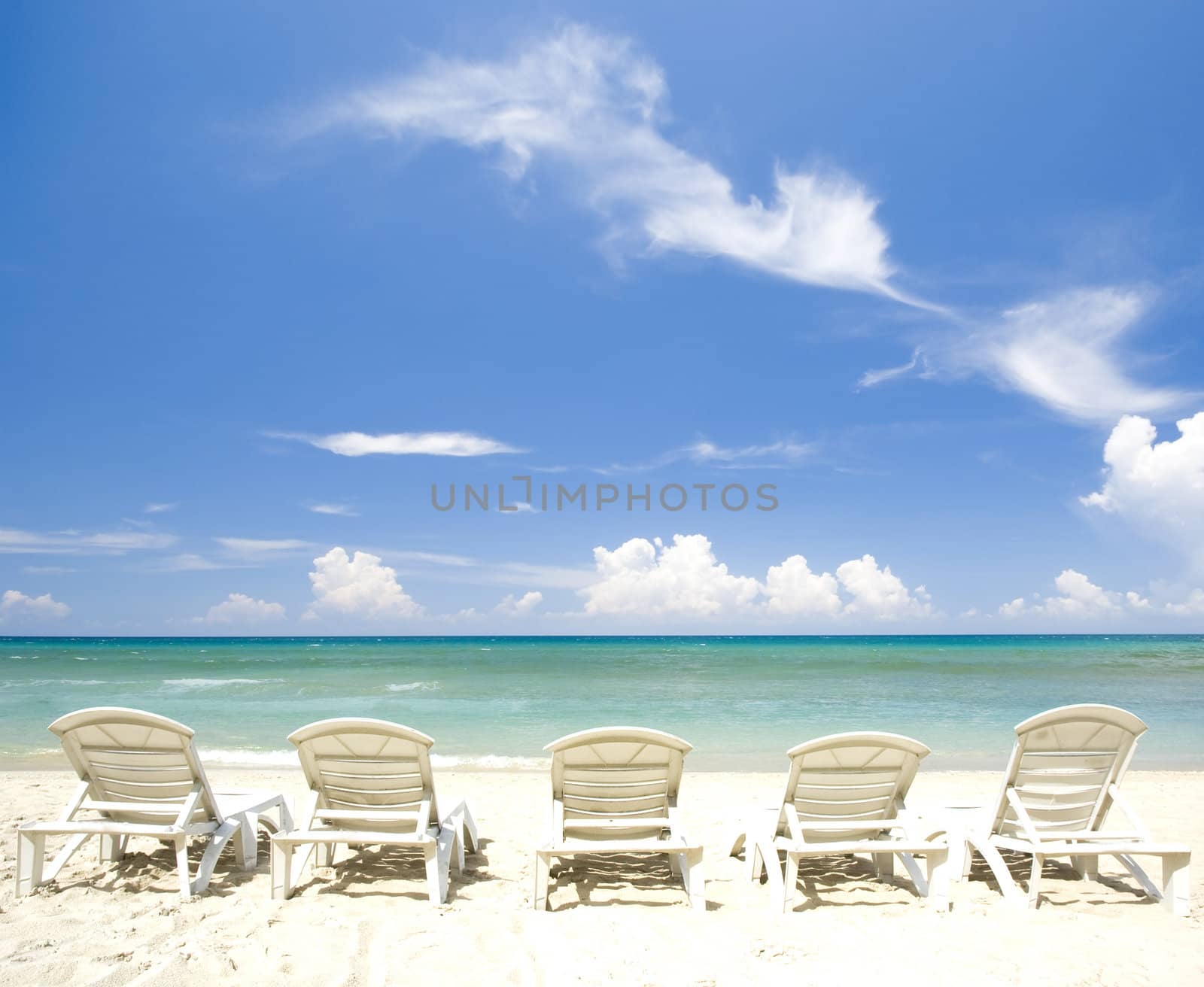 blue beach with chairs 