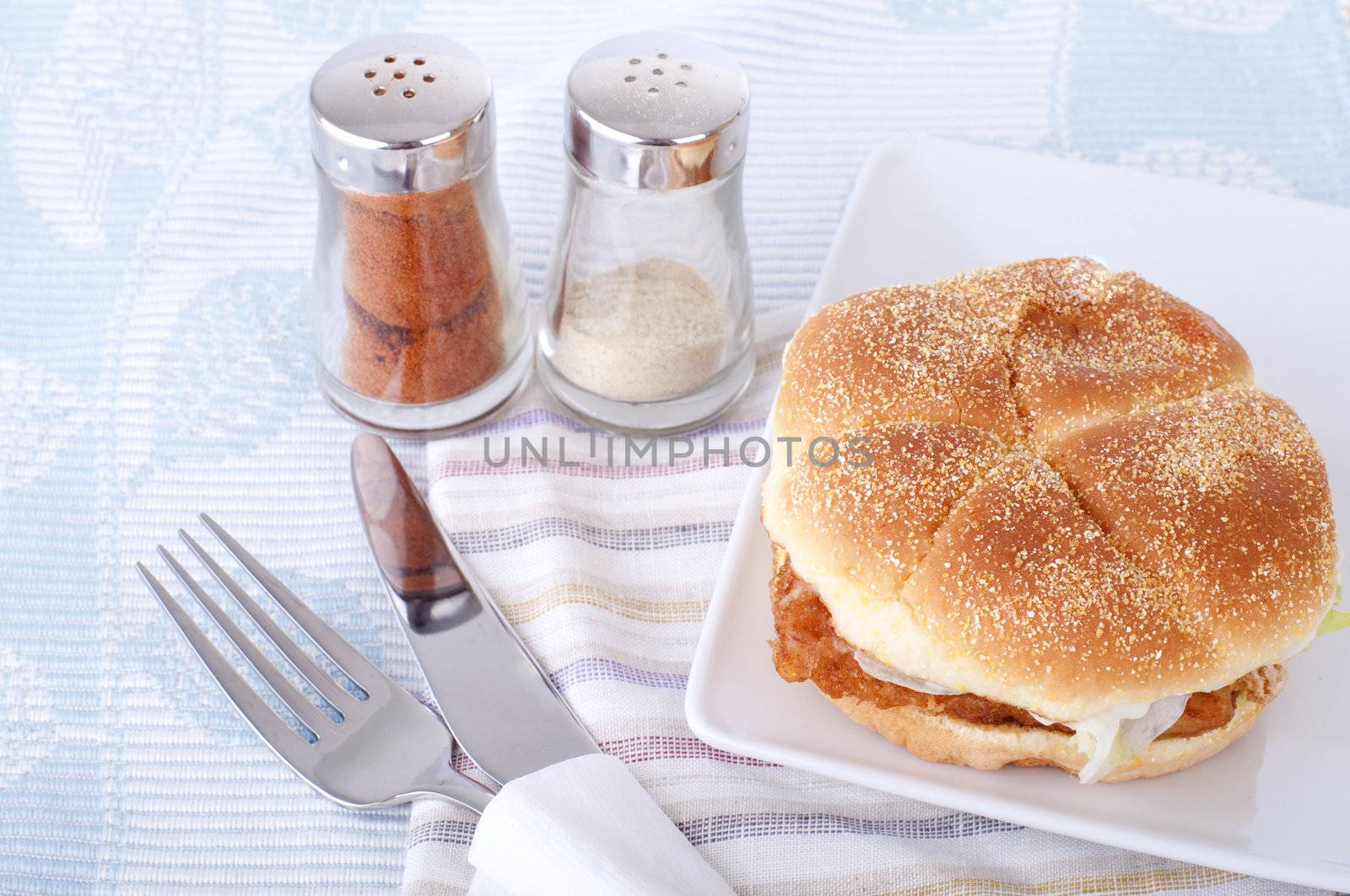 fish burger meal with fork and knife